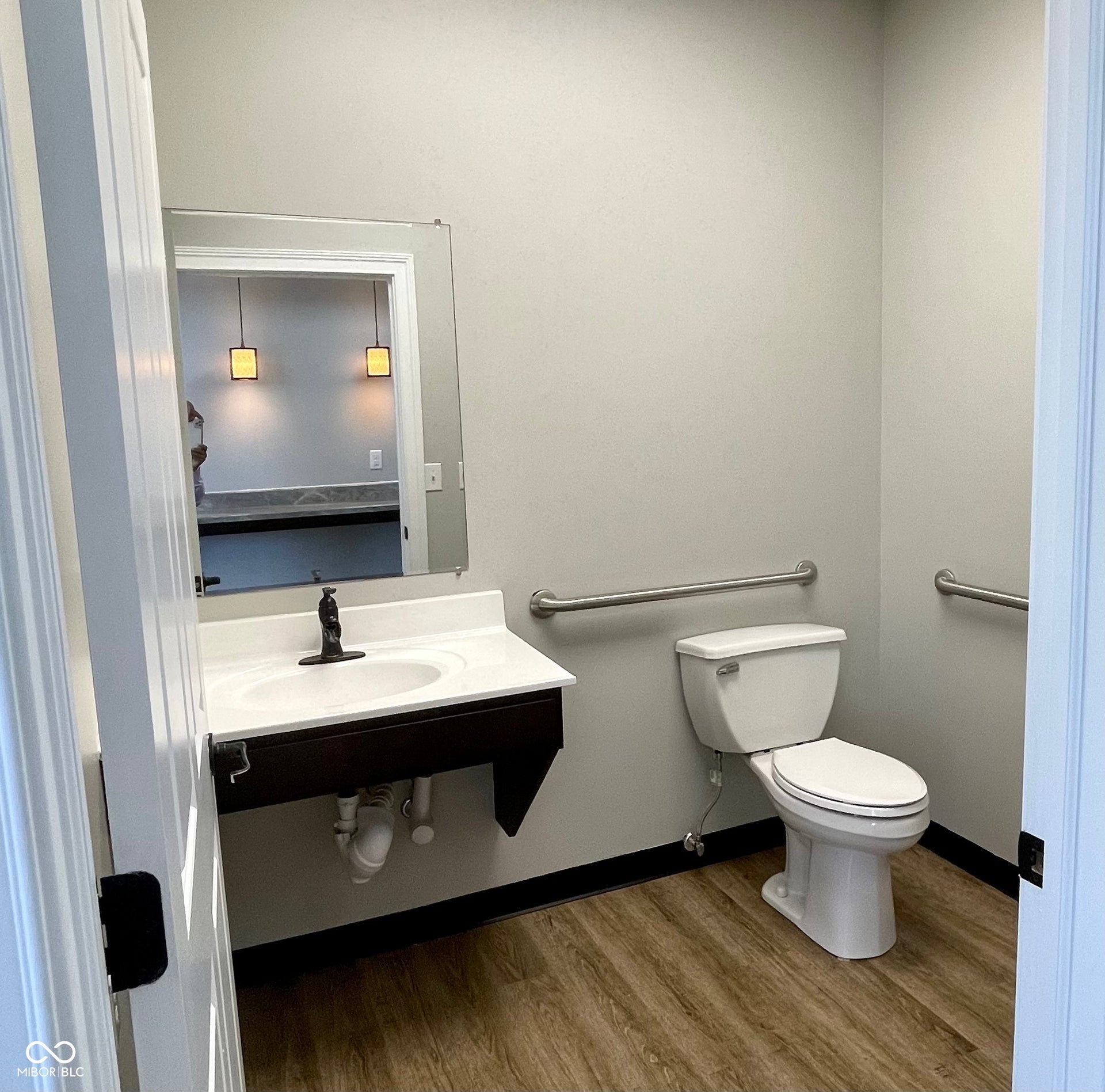 bathroom with dark wood-style floors and vanity