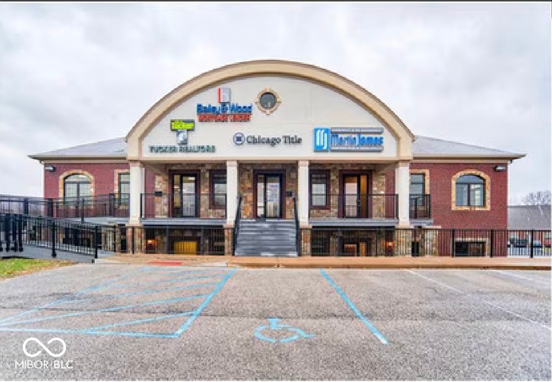 view of commercial property with uncovered parking