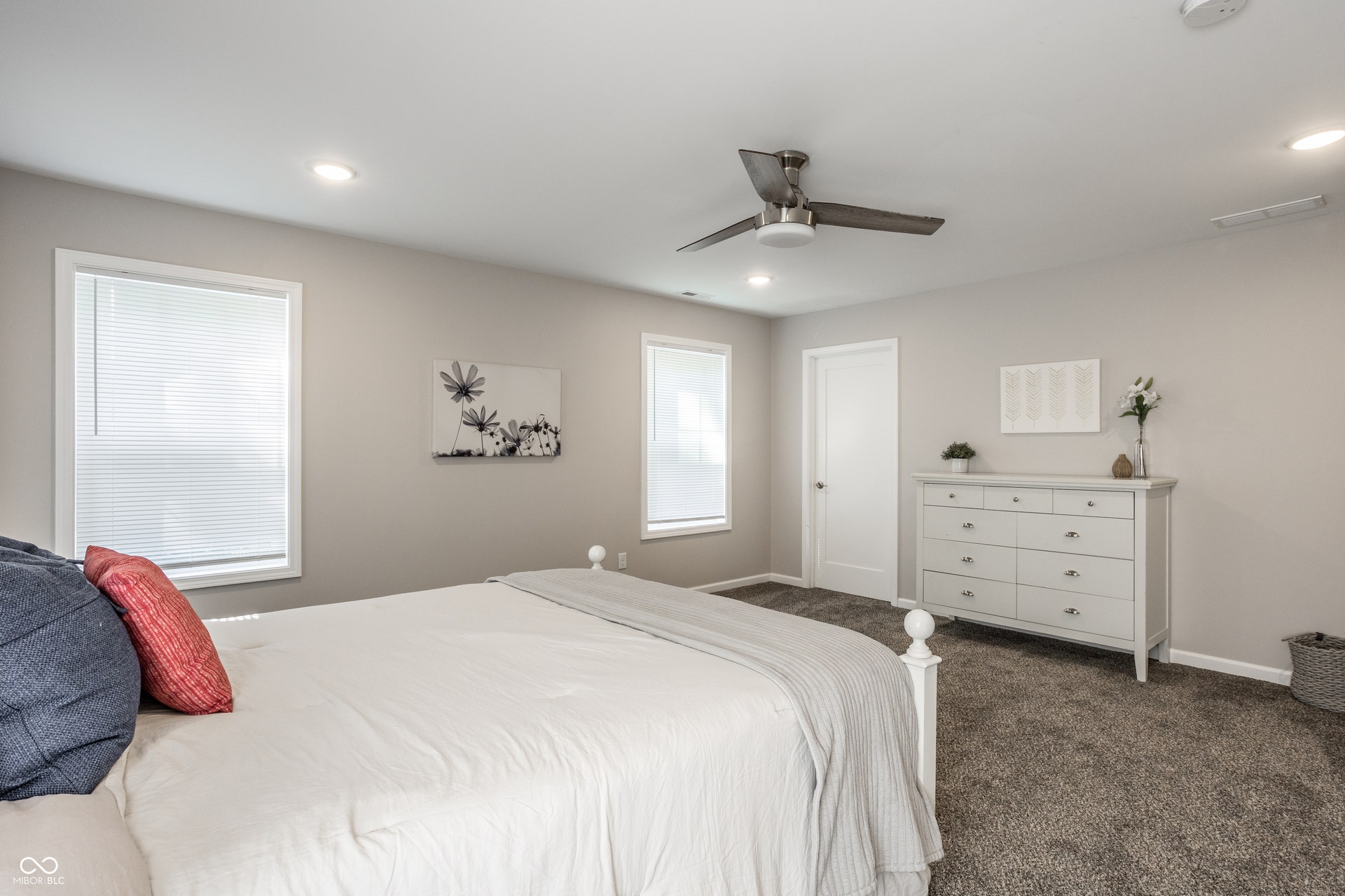2323 E 57th Street, Indianapolis, IN 46220 Recessed lighting, ceiling fan, multiple windows, soft grey wall paint, and grey carpeting