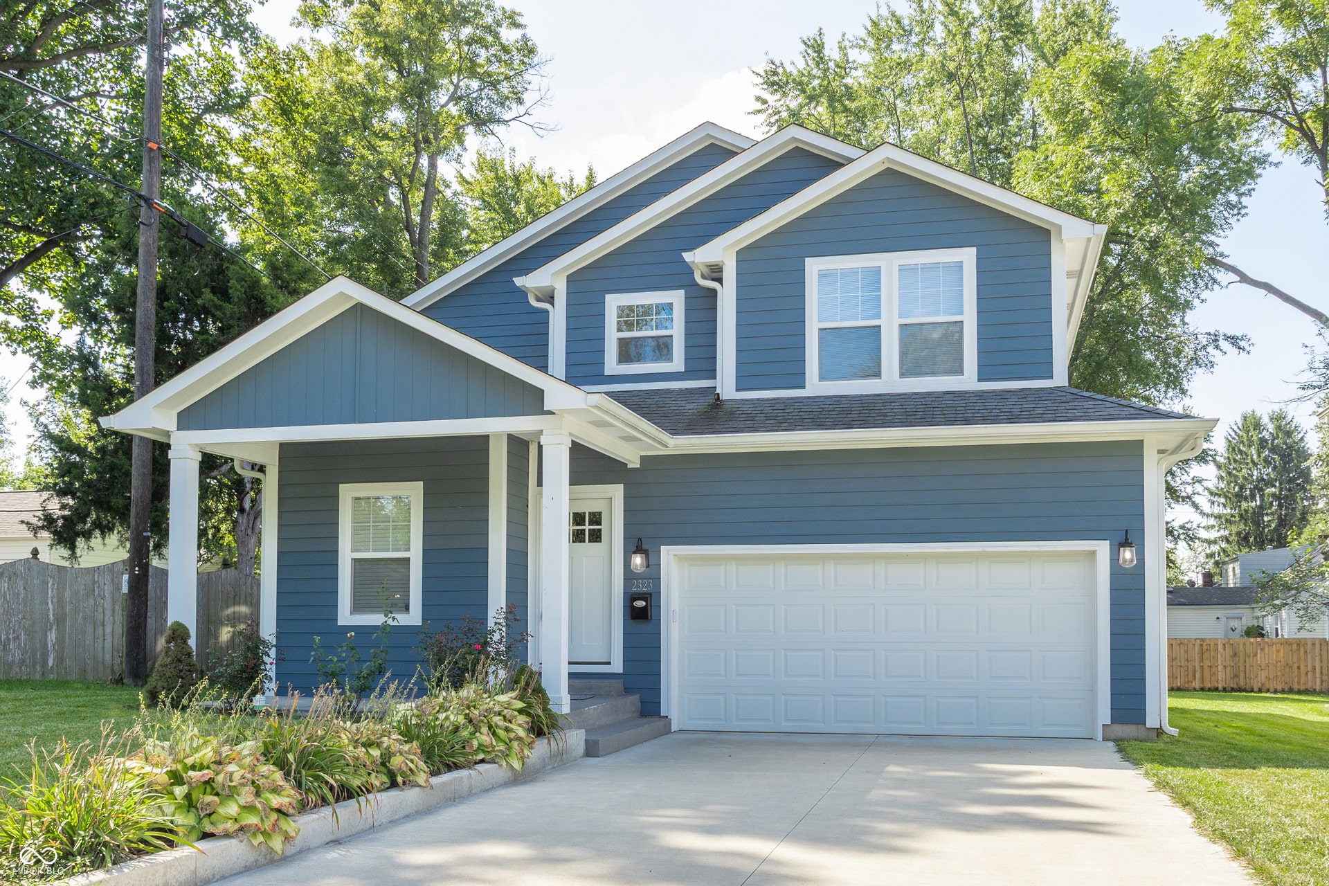 2323 E 57th Street, Indianapolis, IN 46220 Blue siding exterior with white trim accents
