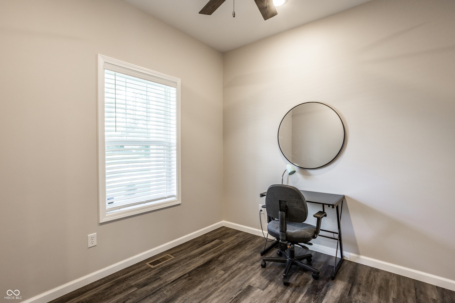 2323 E 57th Street, Indianapolis, IN 46220 Neutral wall color, wood-finish flooring, white window trim, and a ceiling fan with integrated lighting