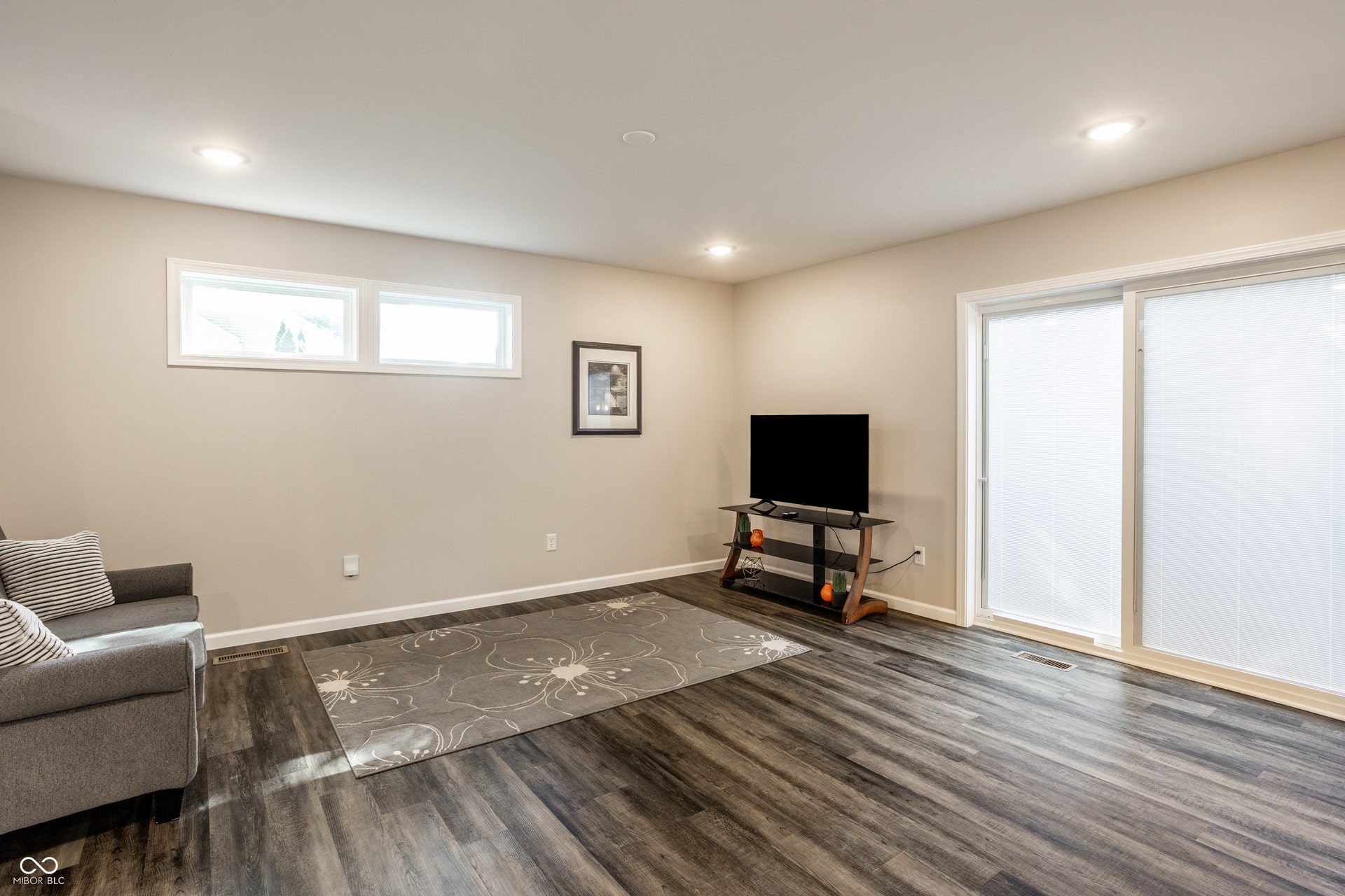 2323 E 57th Street, Indianapolis, IN 46220 Recessed lighting, wood-finish flooring, light-toned walls, multiple windows, and a sliding glass door