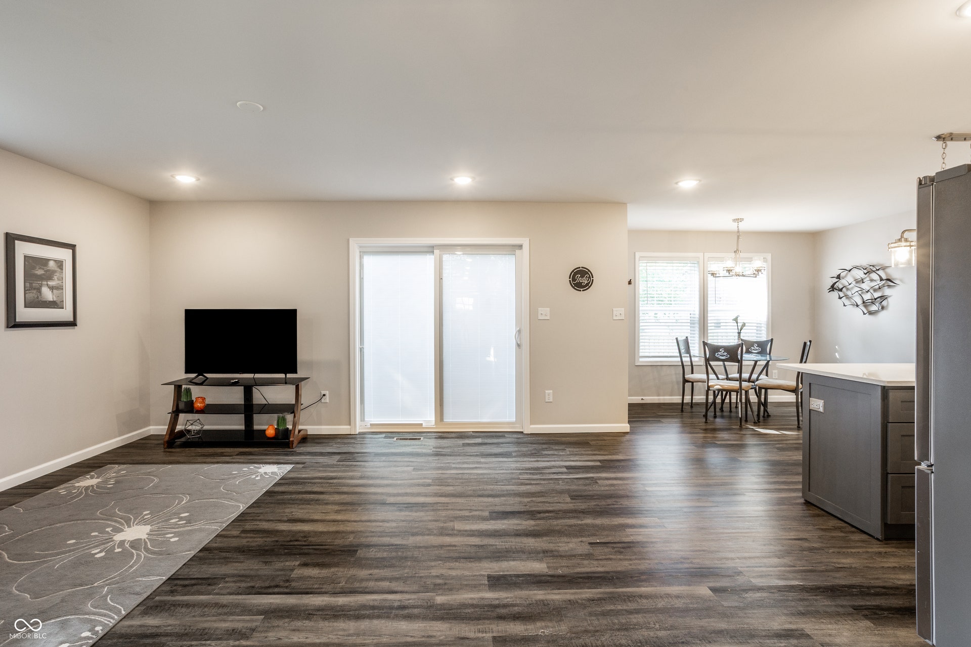2323 E 57th Street, Indianapolis, IN 46220 Wood-finish flooring throughout, recessed lighting, and a sliding glass door