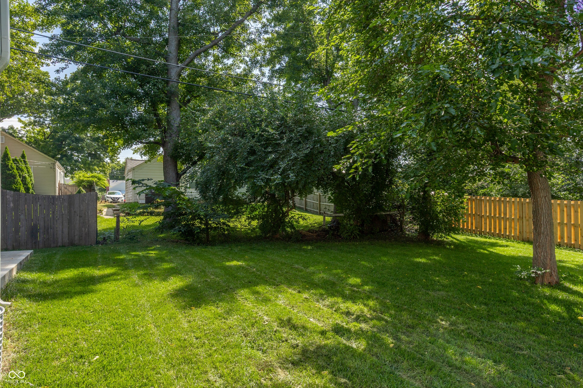 2323 E 57th Street, Indianapolis, IN 46220 Grassed yard area, mature trees, and privacy fencing