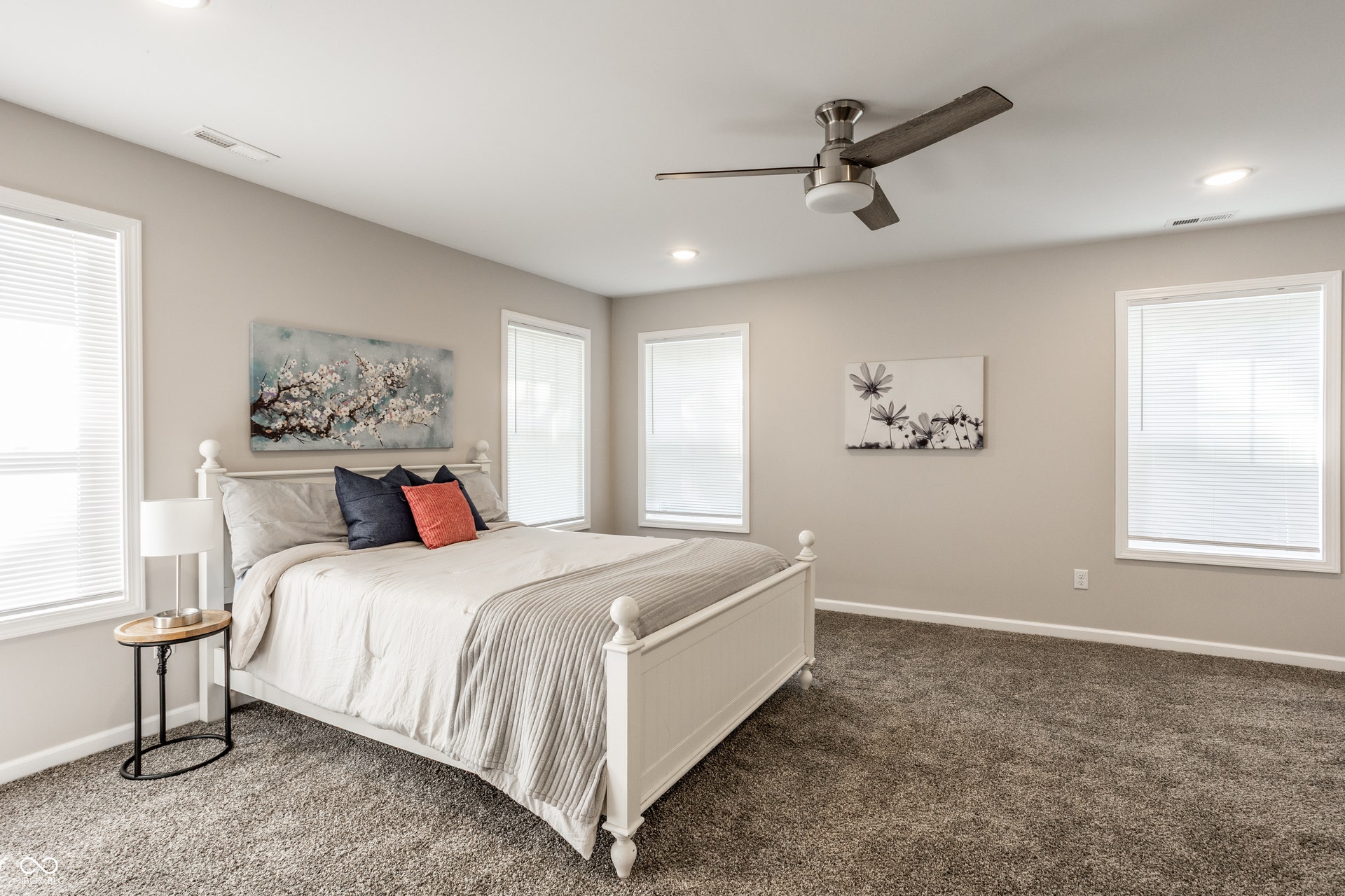 2323 E 57th Street, Indianapolis, IN 46220 Spacious bedroom with plush carpeting, multiple windows, recessed lighting, and a ceiling fan