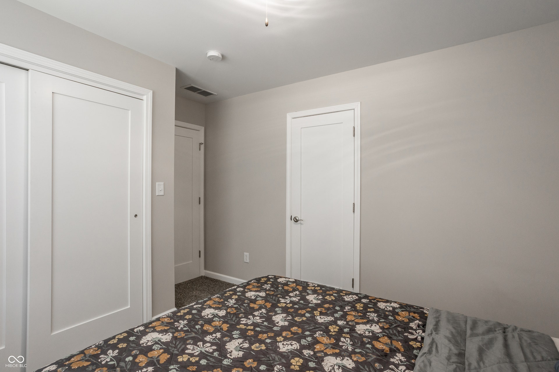 2323 E 57th Street, Indianapolis, IN 46220 Bedroom featuring multiple closet spaces with white panel doors, neutral wall finishes, and recessed ceiling lighting