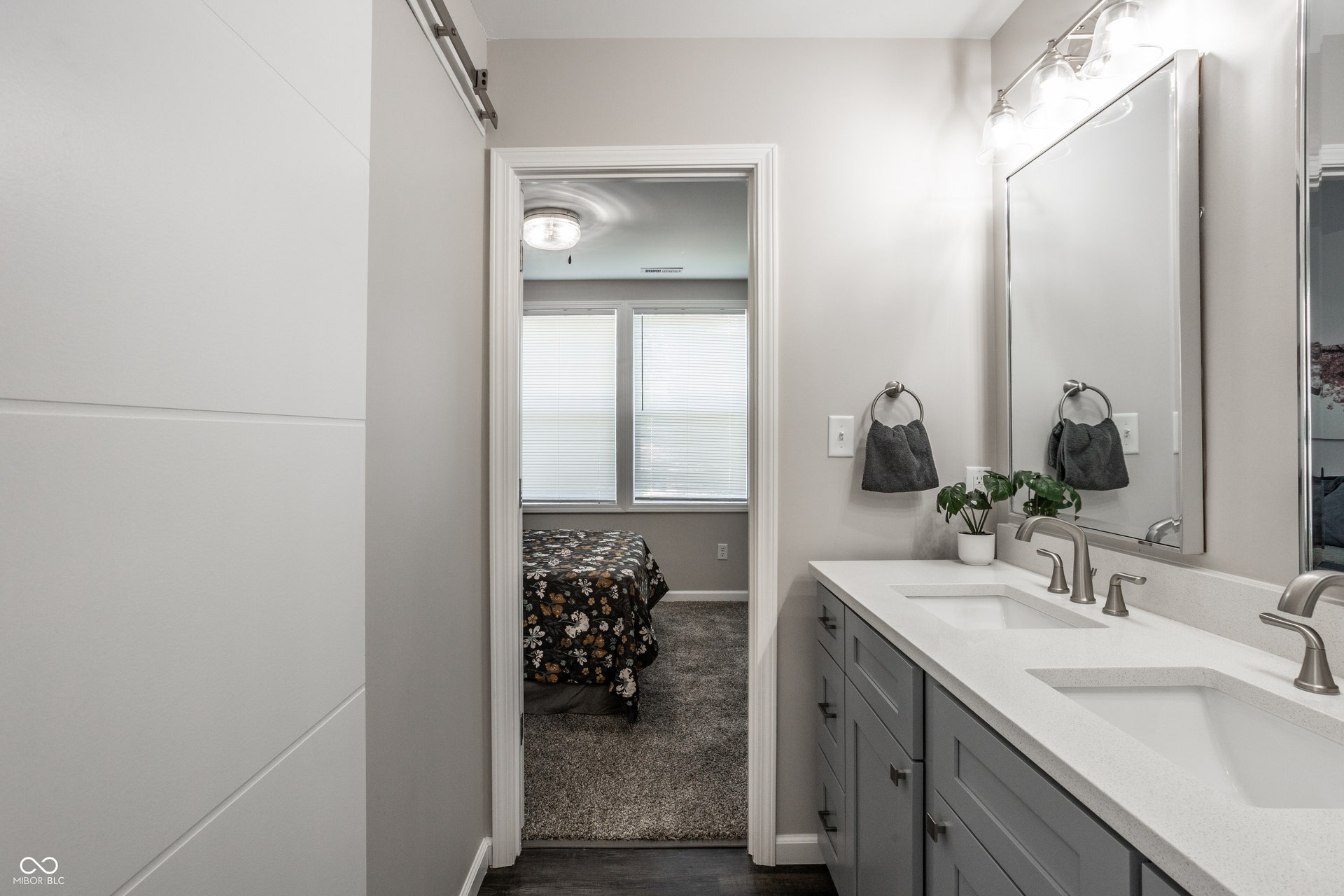 2323 E 57th Street, Indianapolis, IN 46220 Dual sink vanity with light gray cabinetry, white countertops, and brushed nickel fixtures