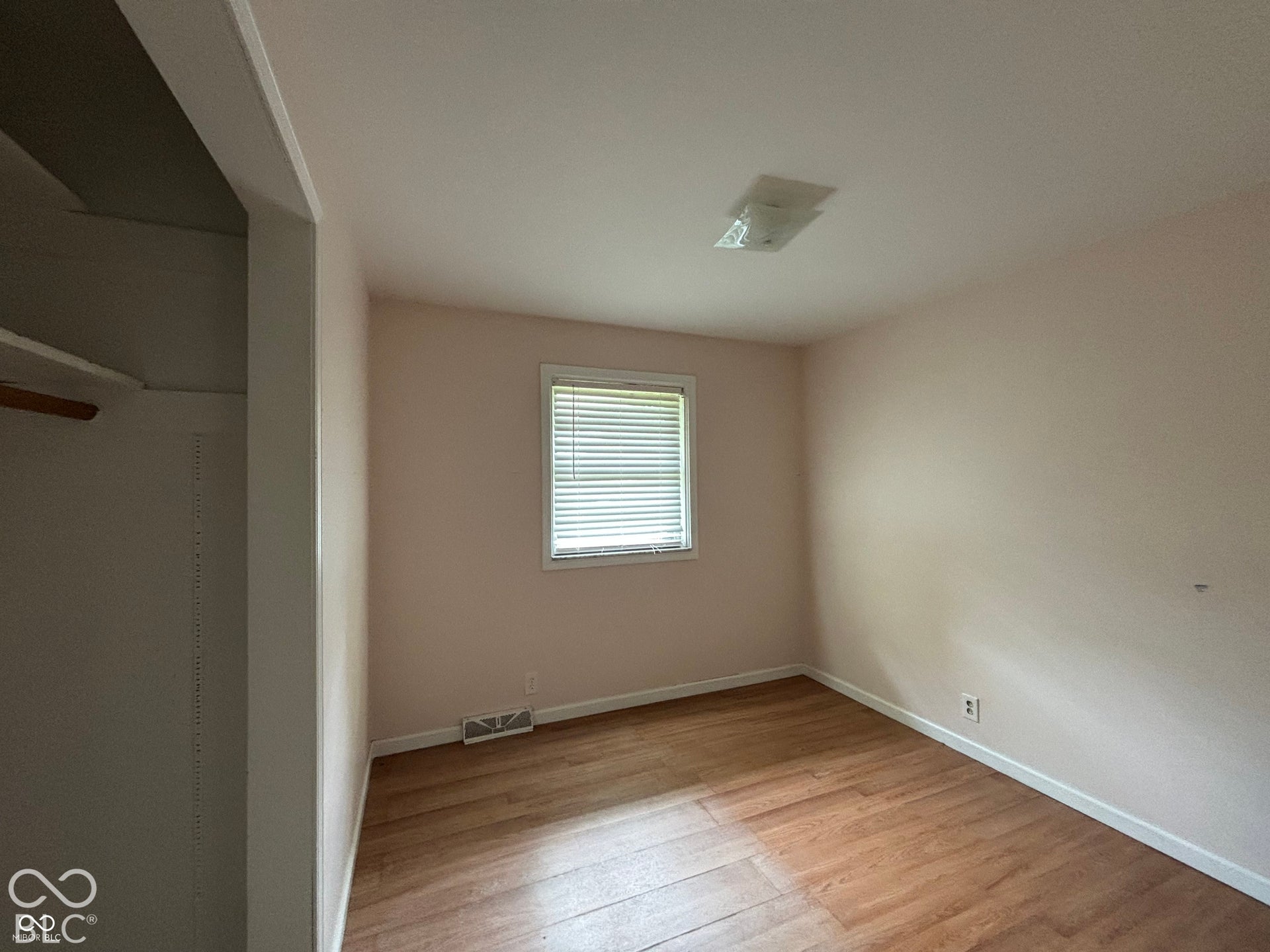 1345 Carroll White Drive, Indianapolis, IN 46219 Wood-finish flooring with white trim, window with blinds, and flush-mount ceiling light