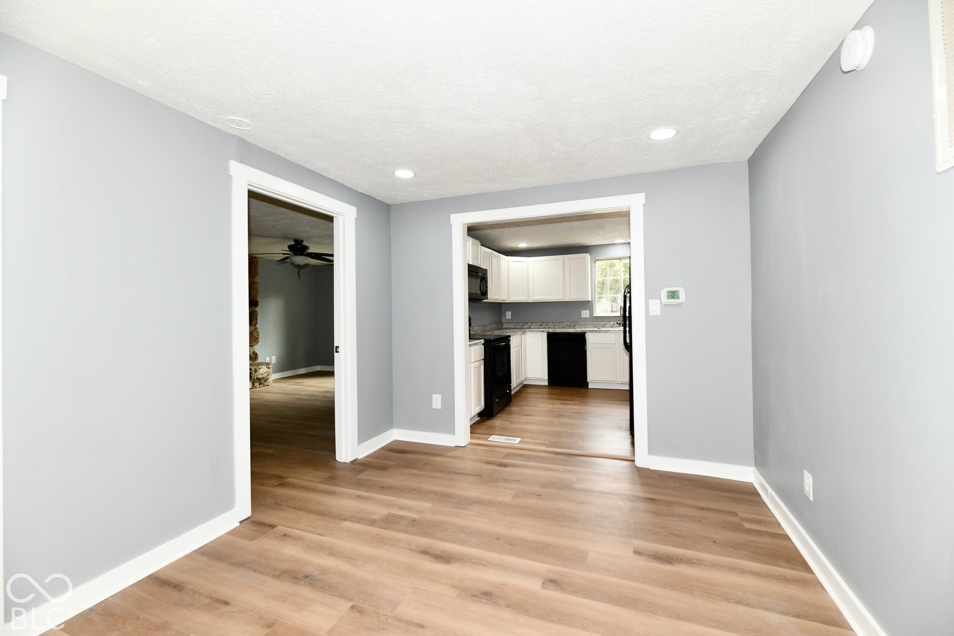 Interior featuring wood-finish flooring, recessed lighting, and crisp neutral wall paint