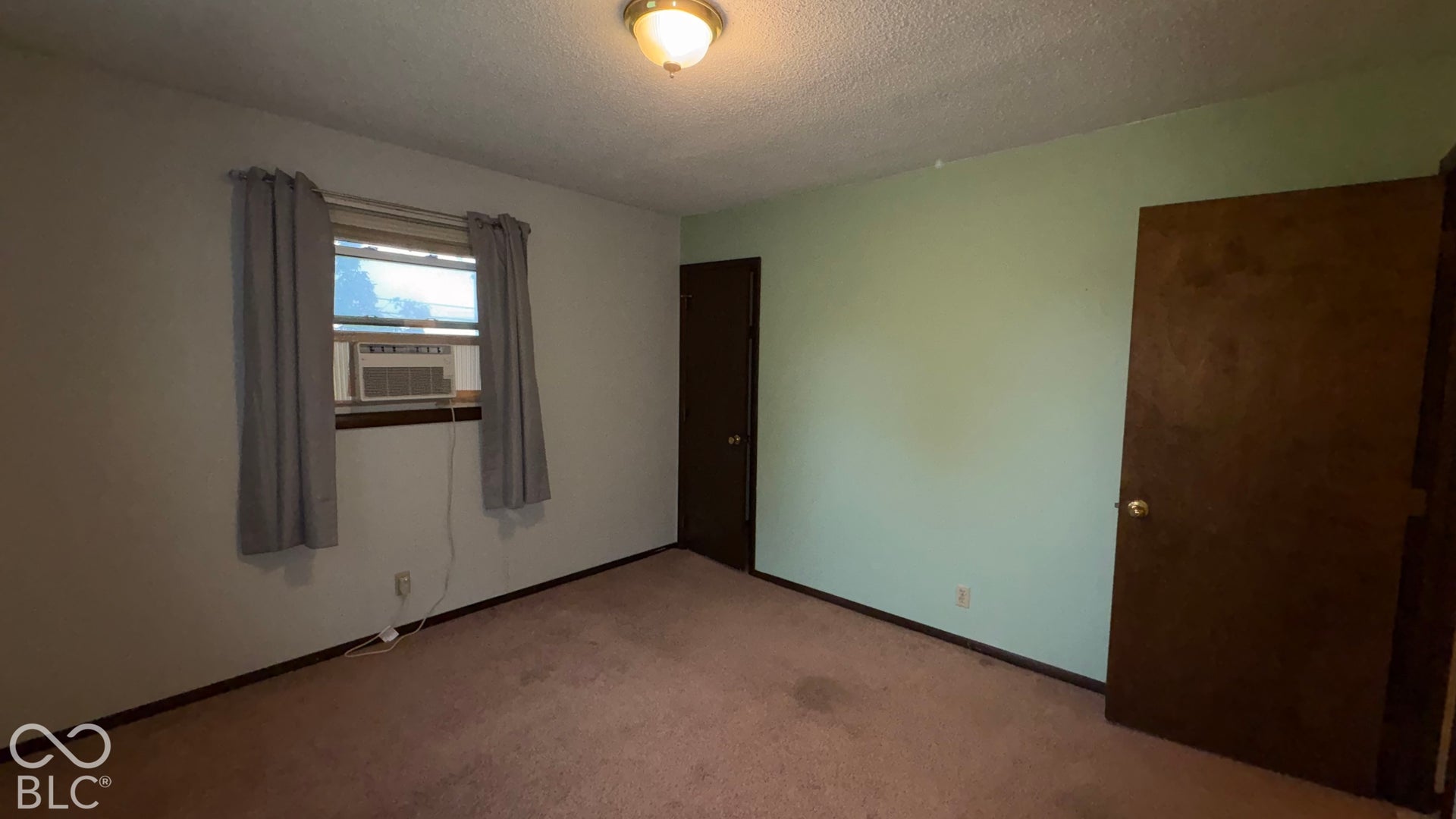 402 E Jackson Street, Farmland, IN 47340 Recessed window featuring a window-mounted air conditioning unit