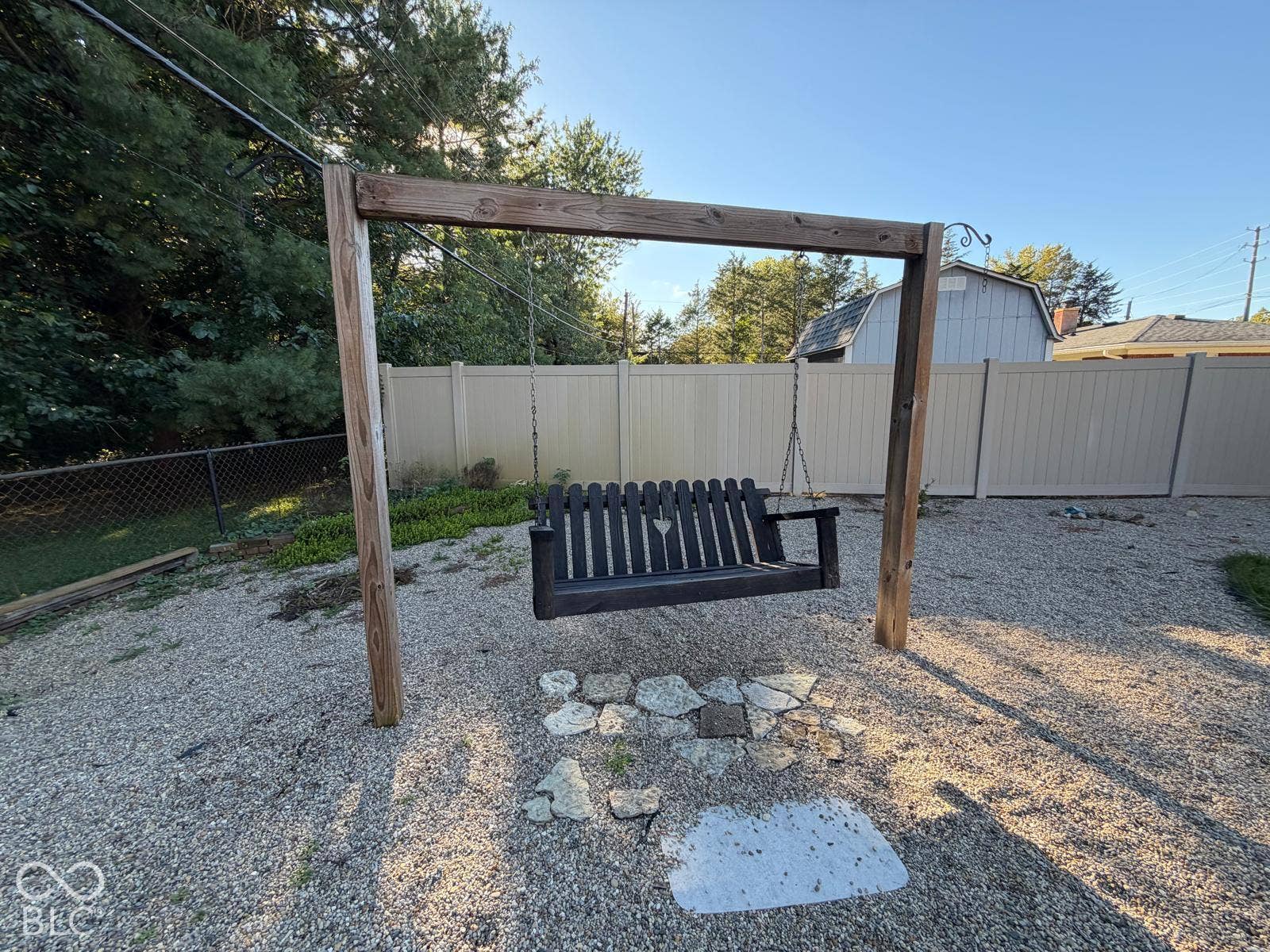 2819 E Edgewood Avenue, Indianapolis, IN 46227 Gravel hardscaping featuring a wooden swing set with a dark slatted swing