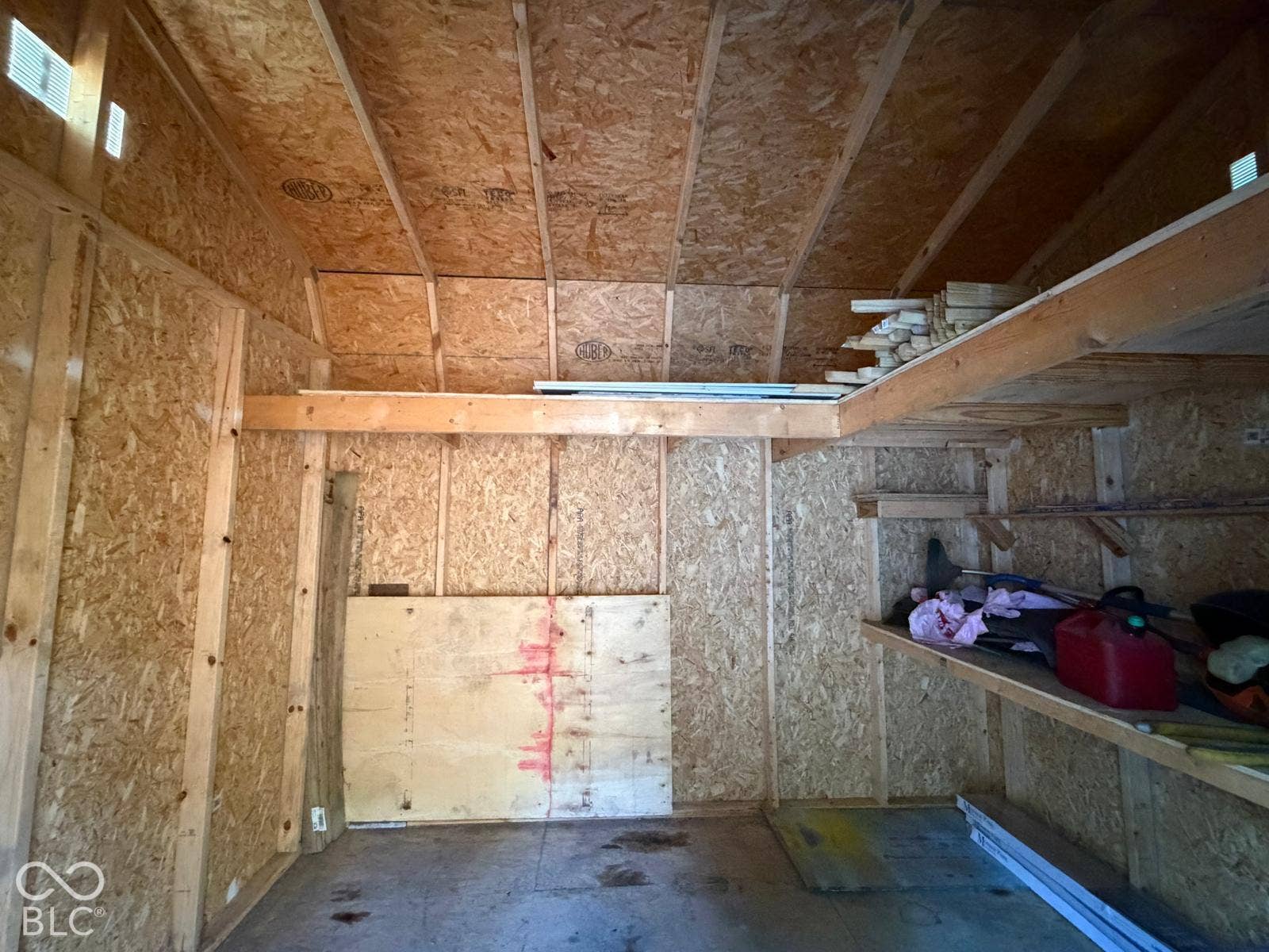 2819 E Edgewood Avenue, Indianapolis, IN 46227 Interior shed space featuring wood-finish walls and ceiling, exposed structural beams, built-in shelving, and a concrete floor