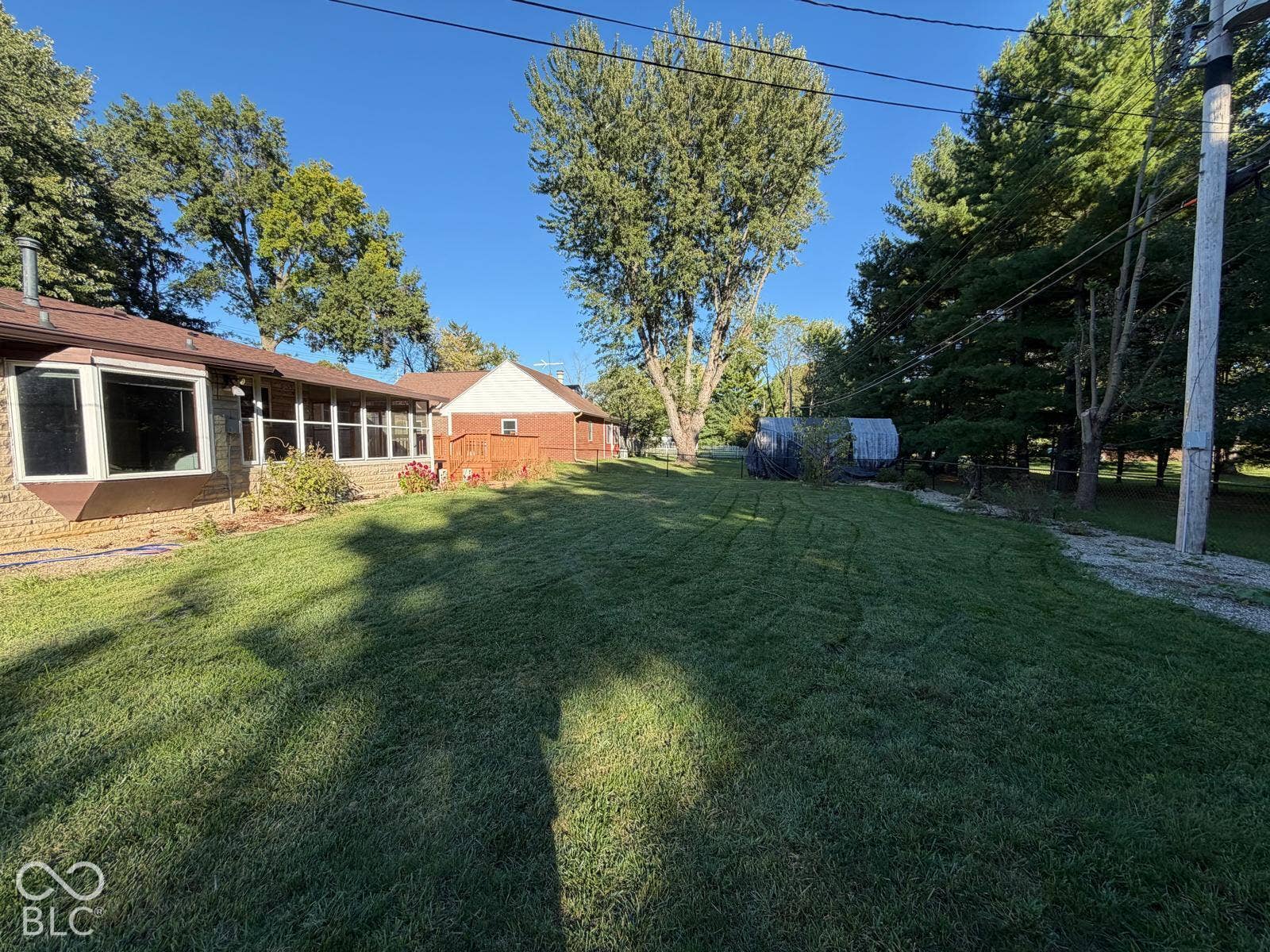 2819 E Edgewood Avenue, Indianapolis, IN 46227 Expansive lawn with mature trees and a stone-clad exterior