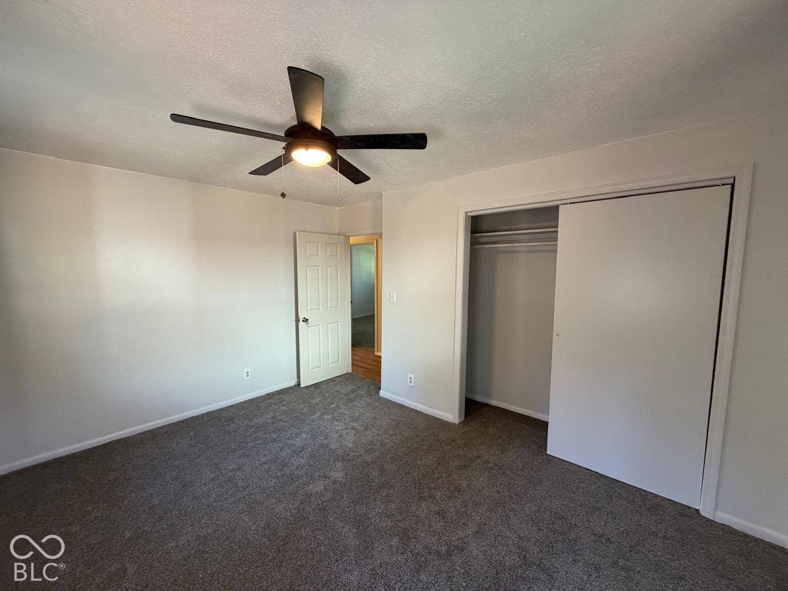 2819 E Edgewood Avenue, Indianapolis, IN 46227 Room with gray carpet flooring, white walls, a ceiling fan with integrated lighting, and a closet with sliding doors