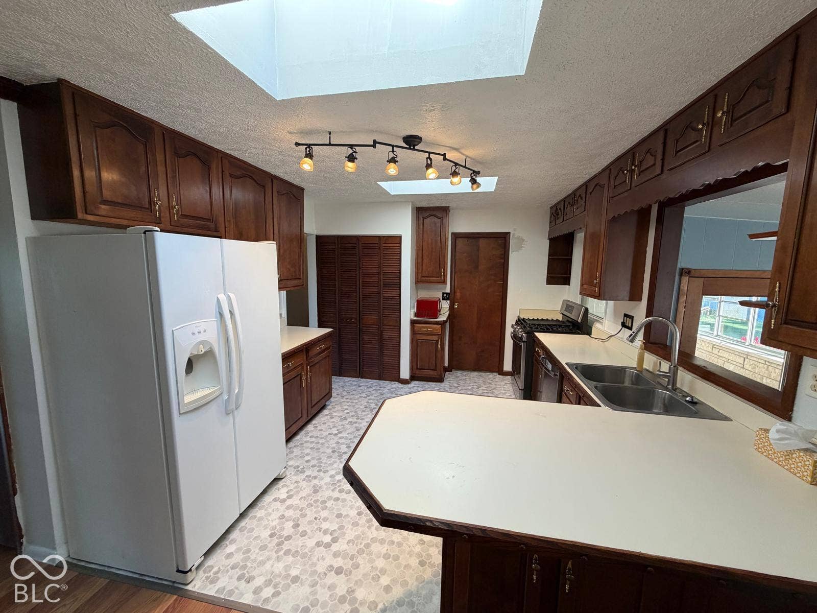 2819 E Edgewood Avenue, Indianapolis, IN 46227 Wood-finish cabinetry, dual skylights, track lighting, and a double basin sink