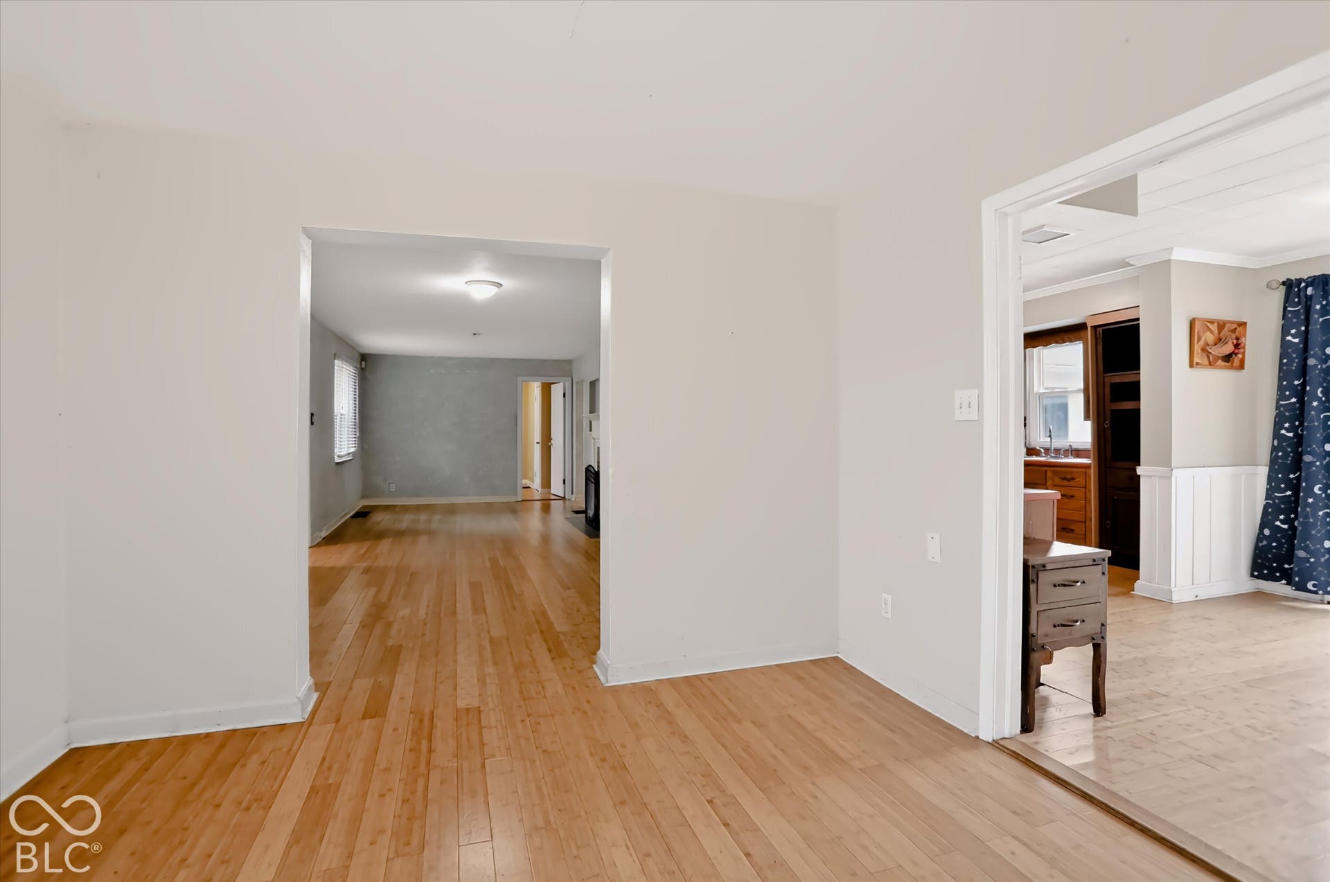Hardwood flooring extending through multiple rooms