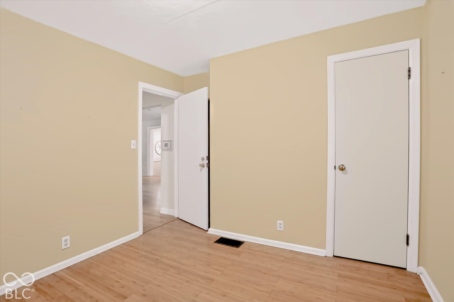 Light wood-finish flooring with a neutral wall color