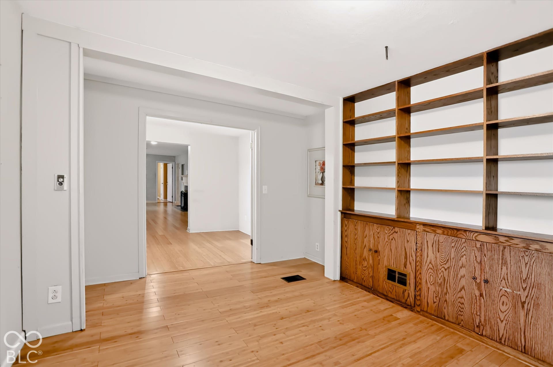 Built-in wood shelving and cabinetry complement the wood-finish flooring