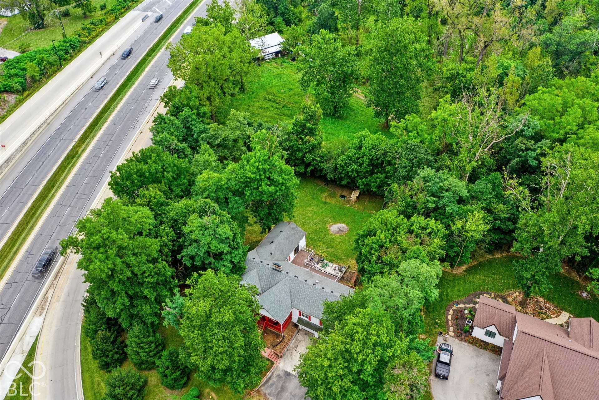 Expansive green spaces featuring mature trees and established landscaping