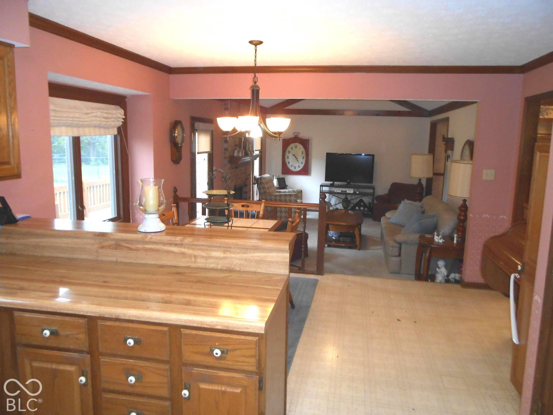 Plenty of countertop space with built-in cabinetry, an open doorway, and a ceiling light fixture