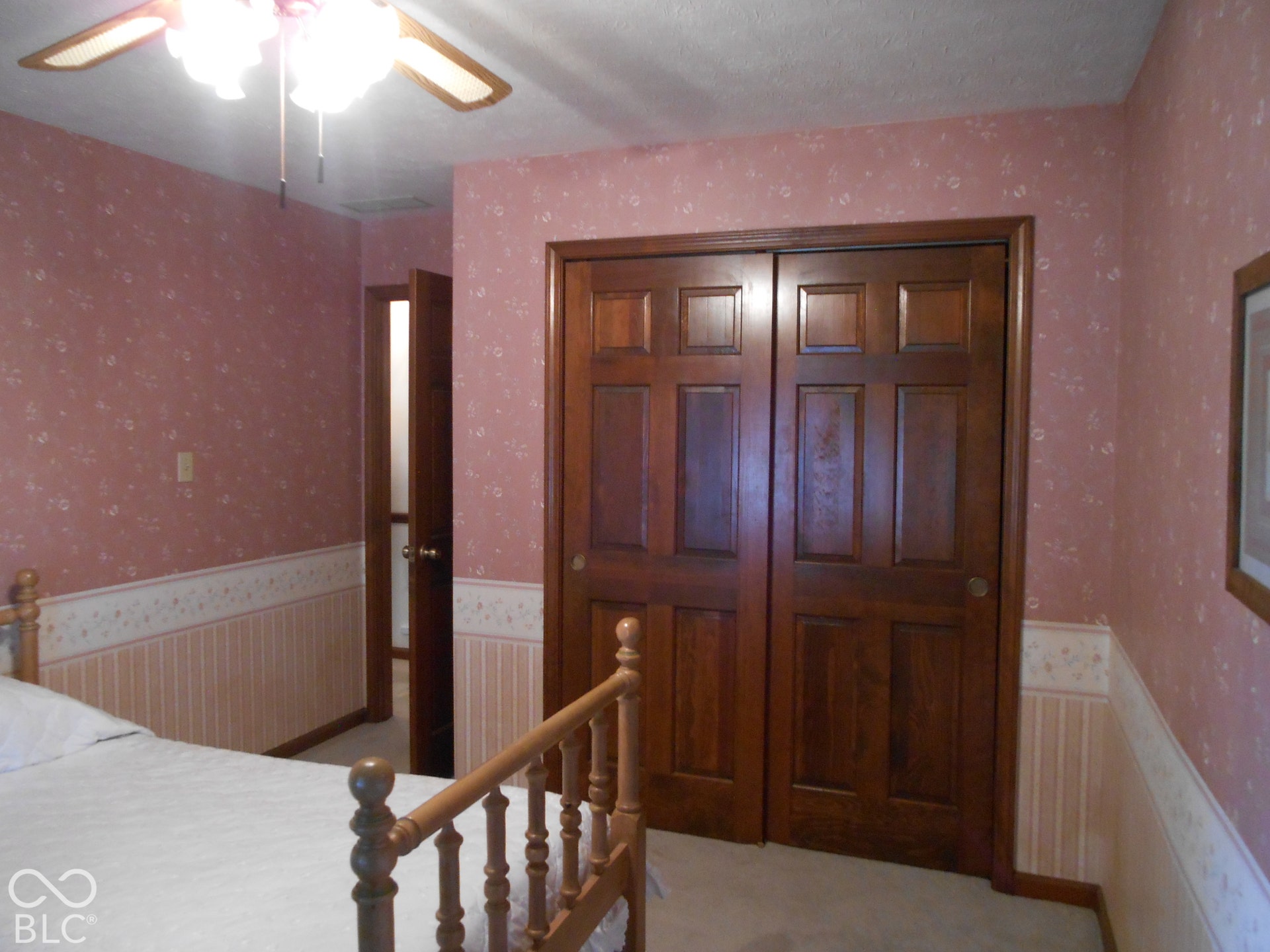 Recessed ceiling fan with light fixture, wood panel doors.