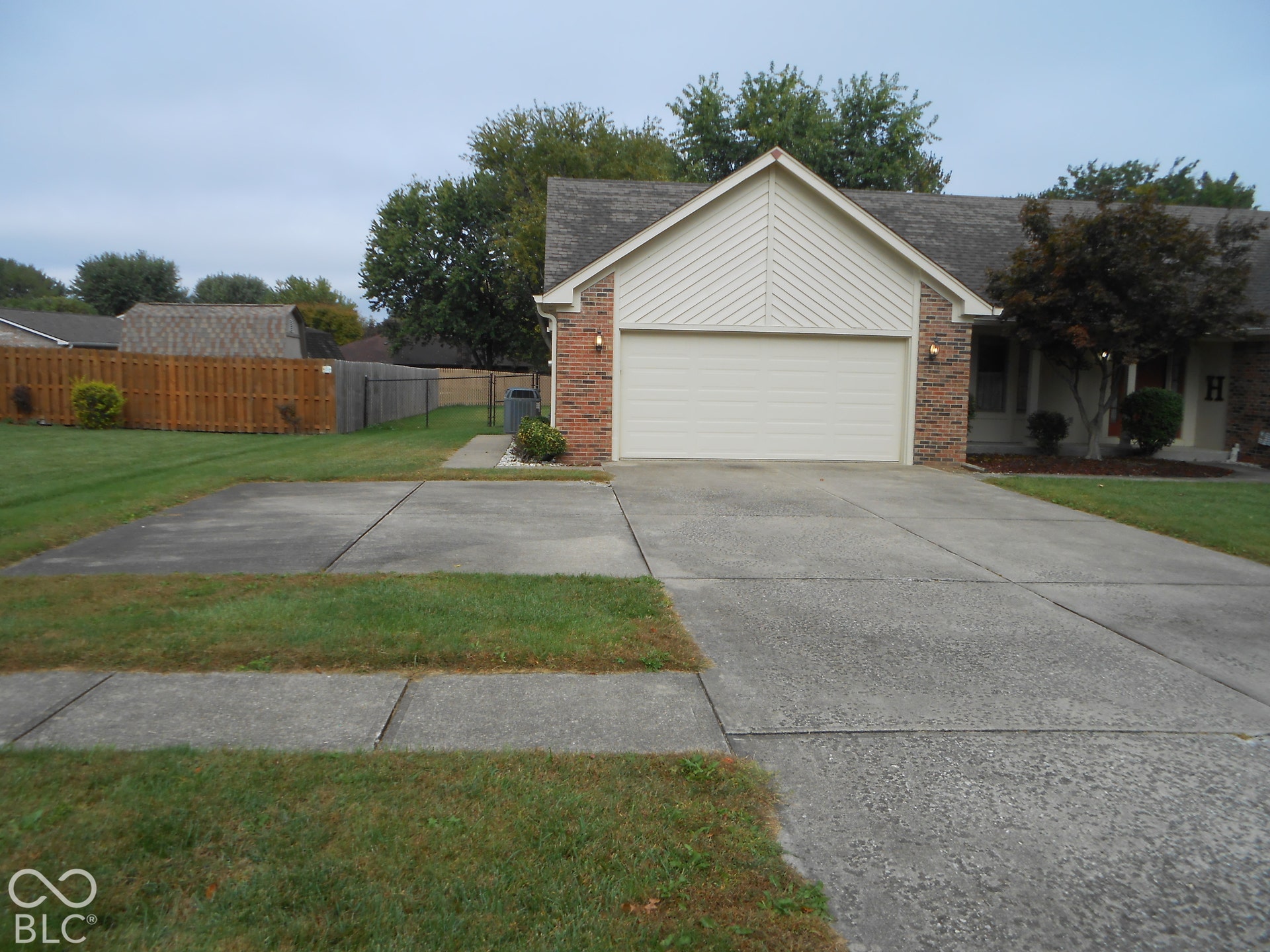 Brick facade with a pitched roof and attached garage