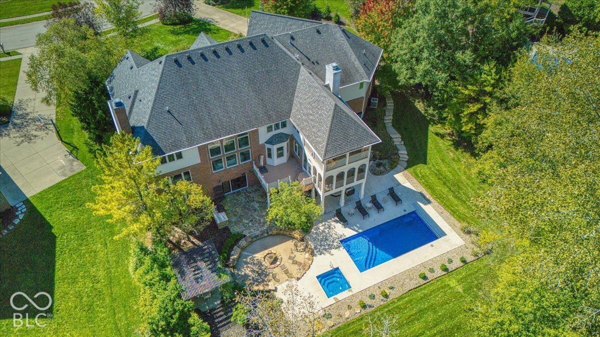 Expansive property featuring a multi-level home, an outdoor pool, a separate spa, and a built-in fire pit area