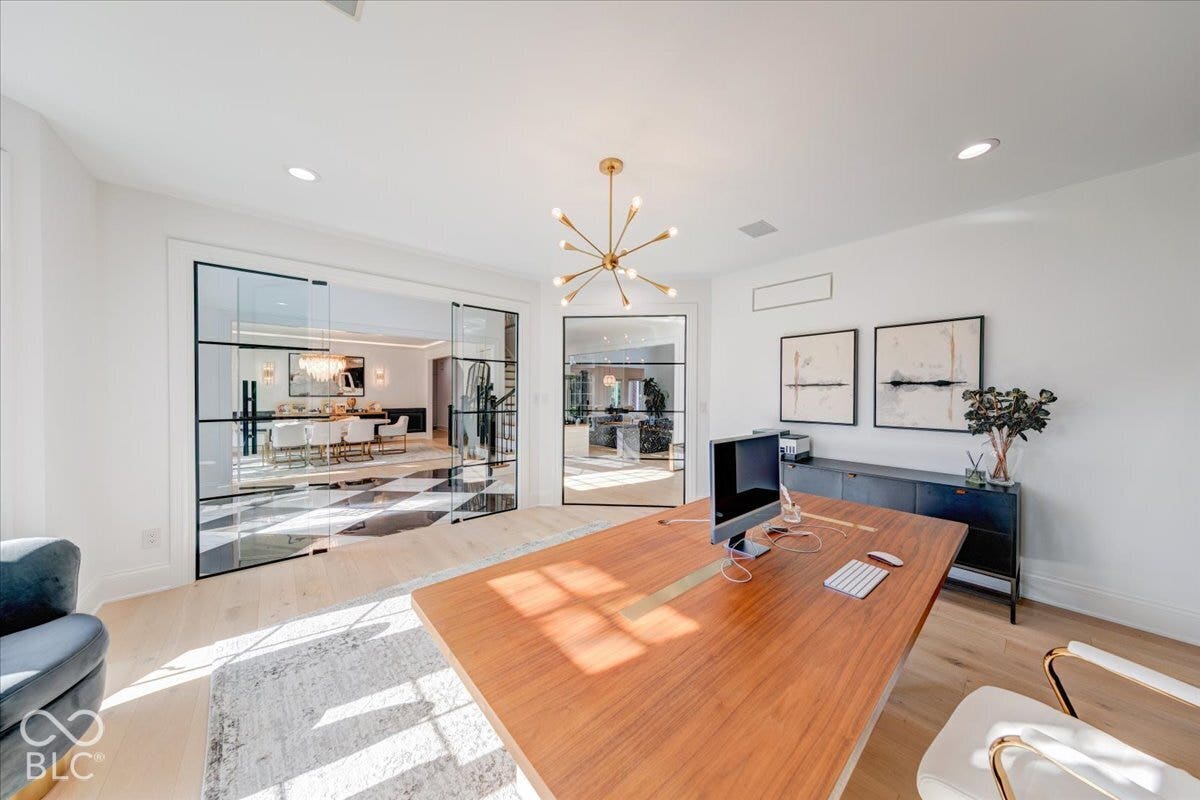 Hardwood-finish flooring, recessed lighting, and a sputnik chandelier
