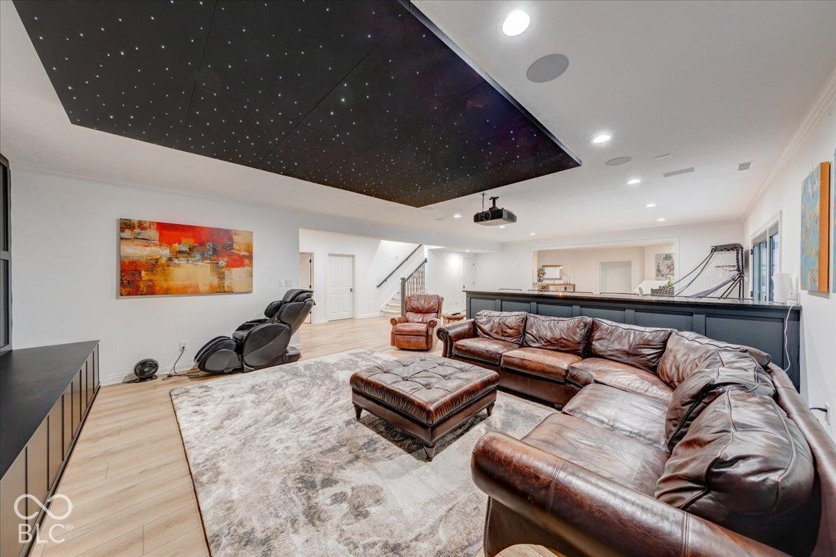 Recessed ceiling lighting, wood-finish flooring, and a built-in media console