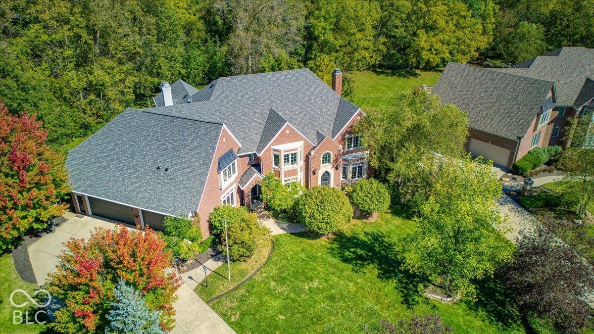Traditional brick exterior with multiple gables and a multi-car garage