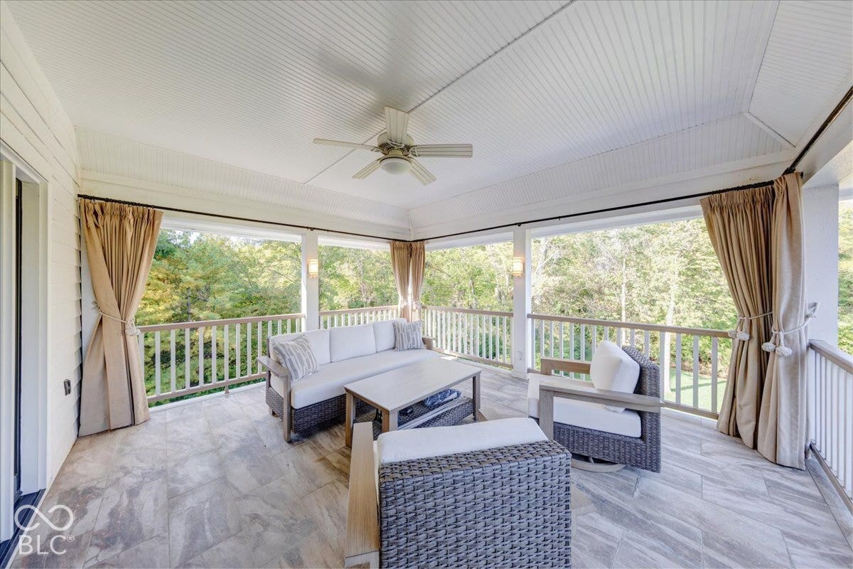 Spacious covered porch with planked ceiling, ceiling fan, recessed lighting, and tile flooring