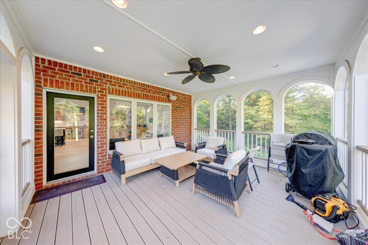 Covered porch featuring a ceiling fan, recessed lighting, and a brick exterior wall