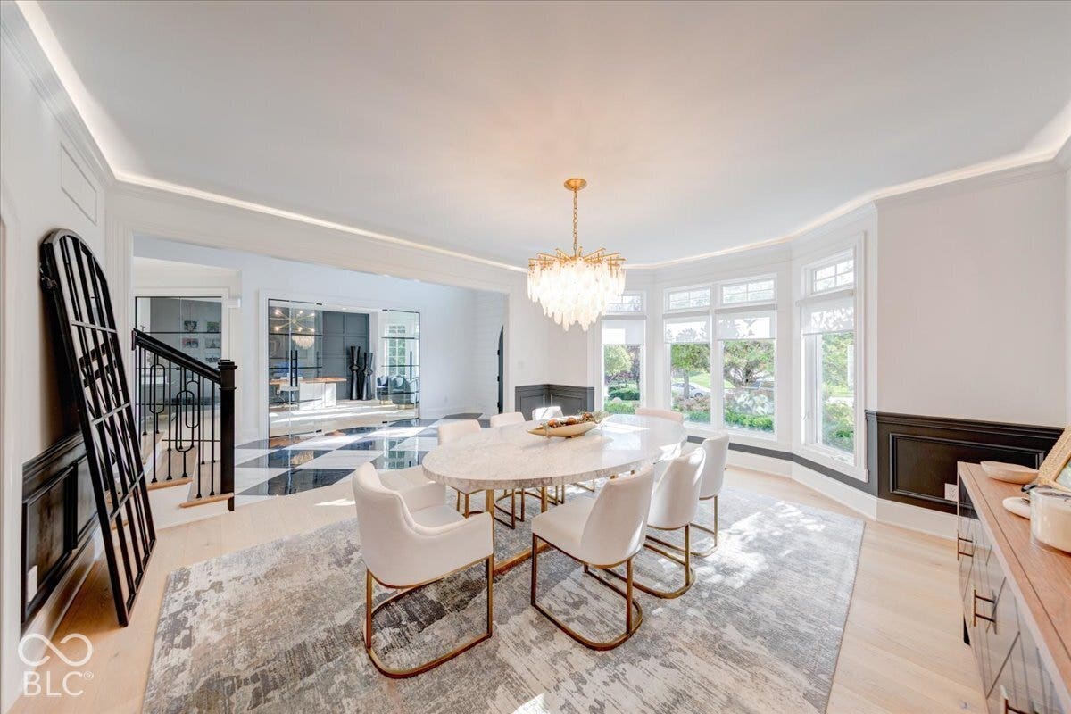Recessed lighting, bay window, chandelier, wood-finish flooring, and crown molding