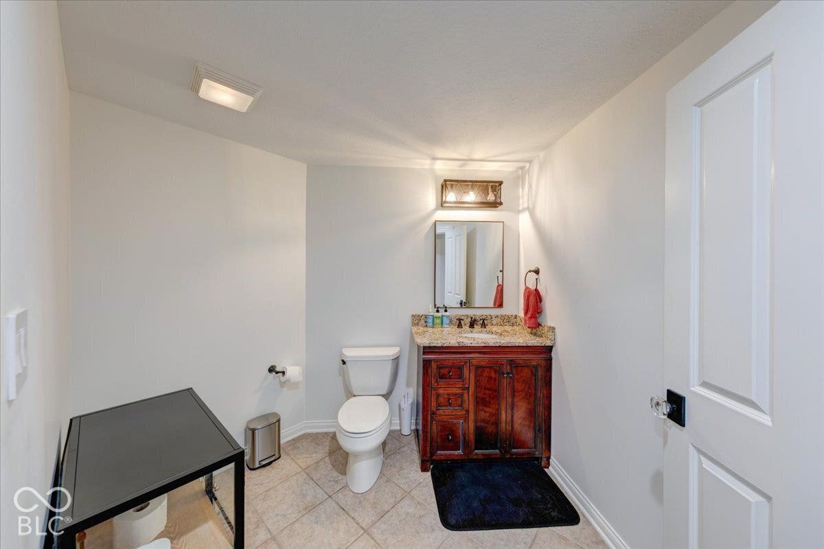 Wood-finish vanity with a stone countertop and under-mount sink