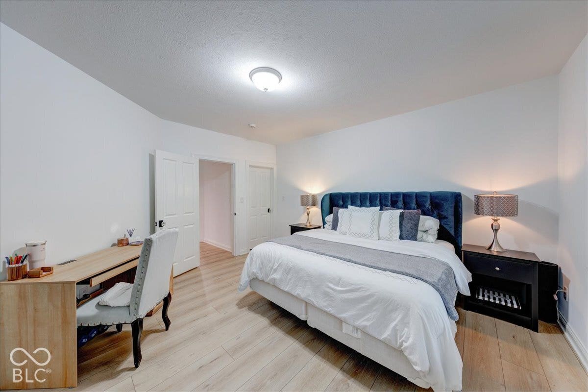 Light wood-finish flooring, white walls, and a ceiling-mounted light fixture