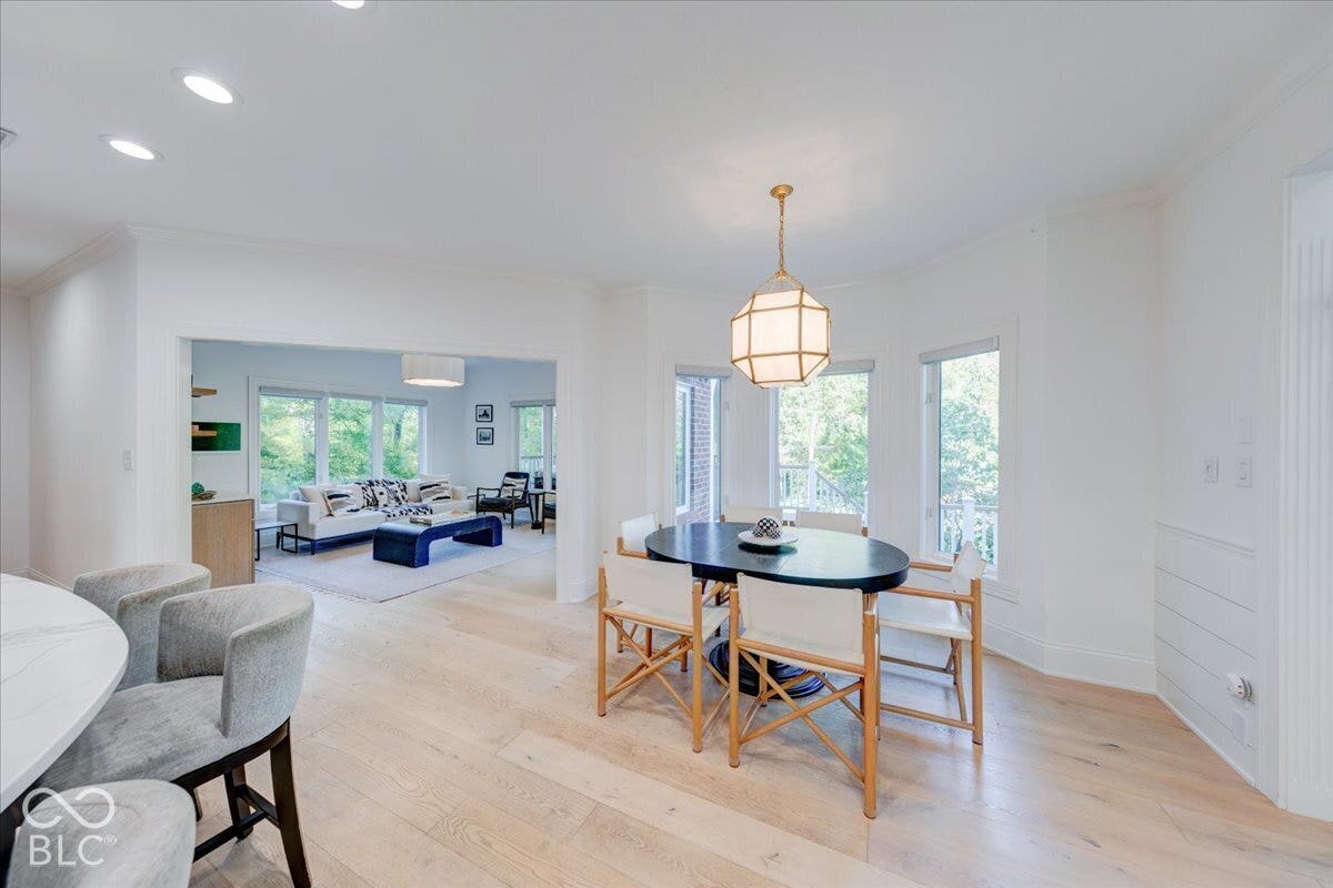 Wood-finish flooring throughout, recessed lighting, and a modern globe pendant light