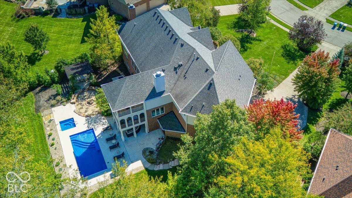 Expansive backyard featuring a swimming pool, integrated spa, and extensive patio space
