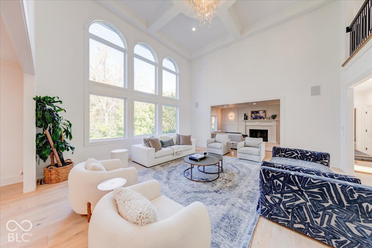 Expansive living area featuring soaring ceilings and wood-finish flooring