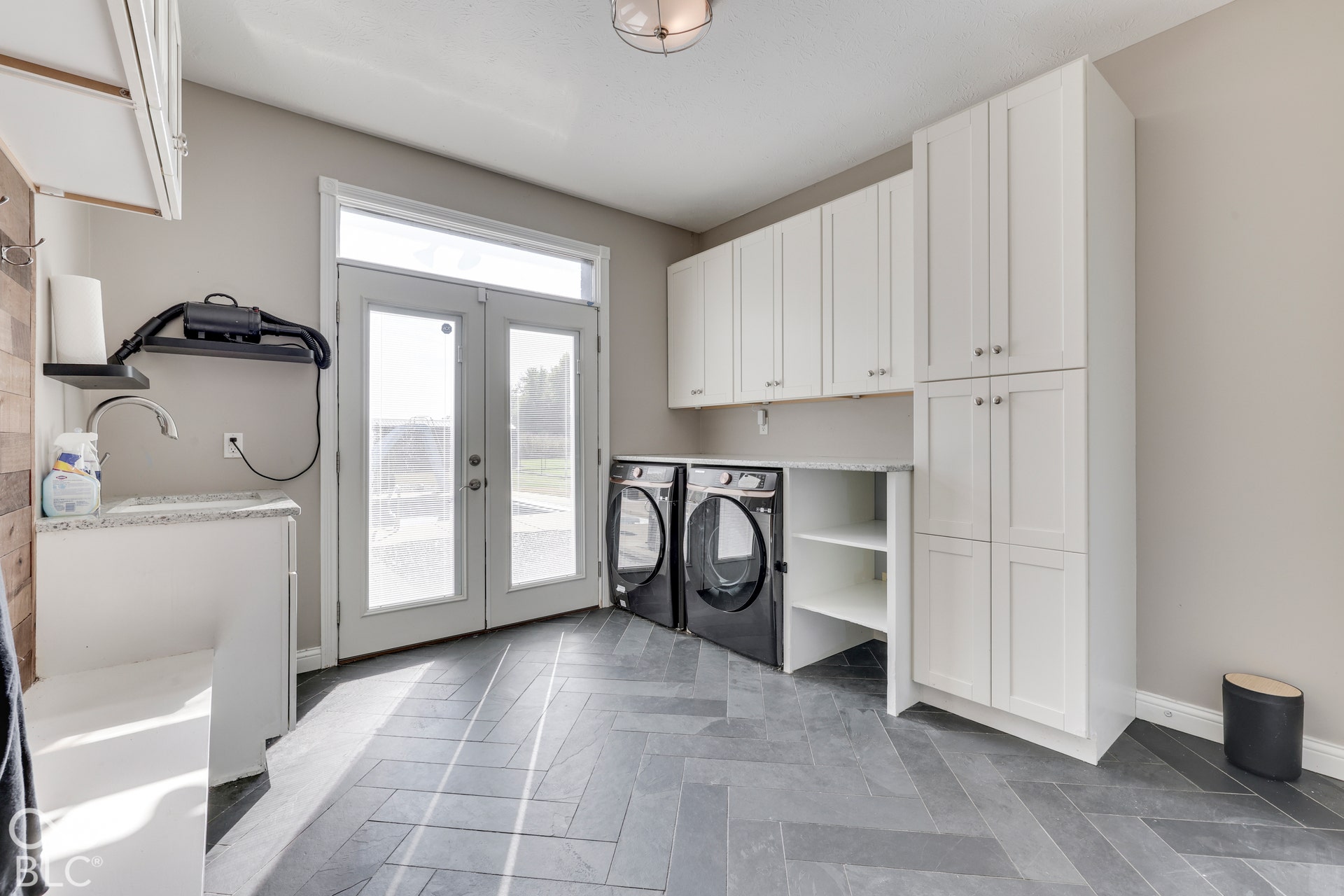 1307 E 125 S, Franklin, IN 46131 Main laundry with utility sink and patio doors leading to the back patio and pool.