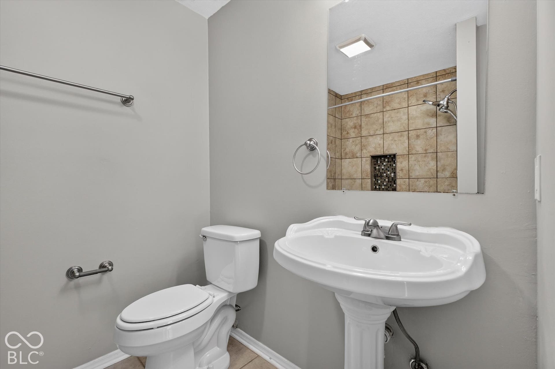 Primary bathroom featuring a pedestal sink and a tiled shower/bathtub combination