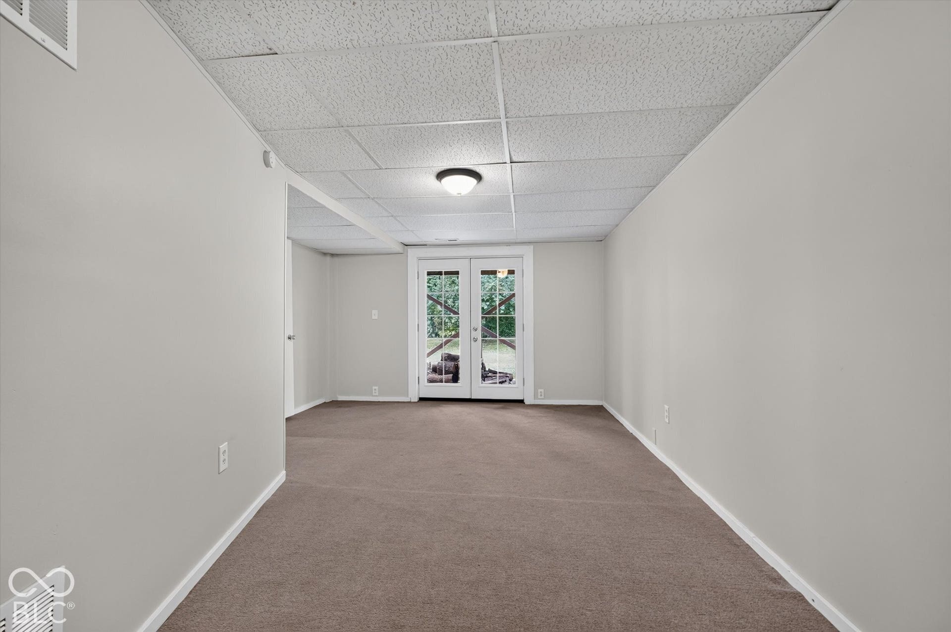 Spacious 4th bedroom featuring carpet and outside access