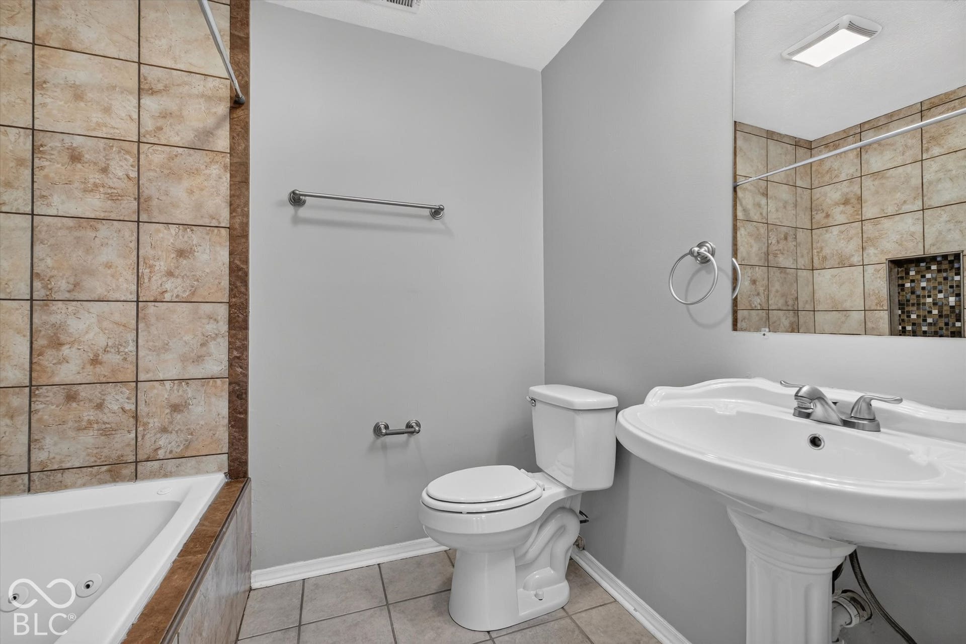 Primary bathroom featuring a pedestal sink and a tiled shower/bathtub combination
