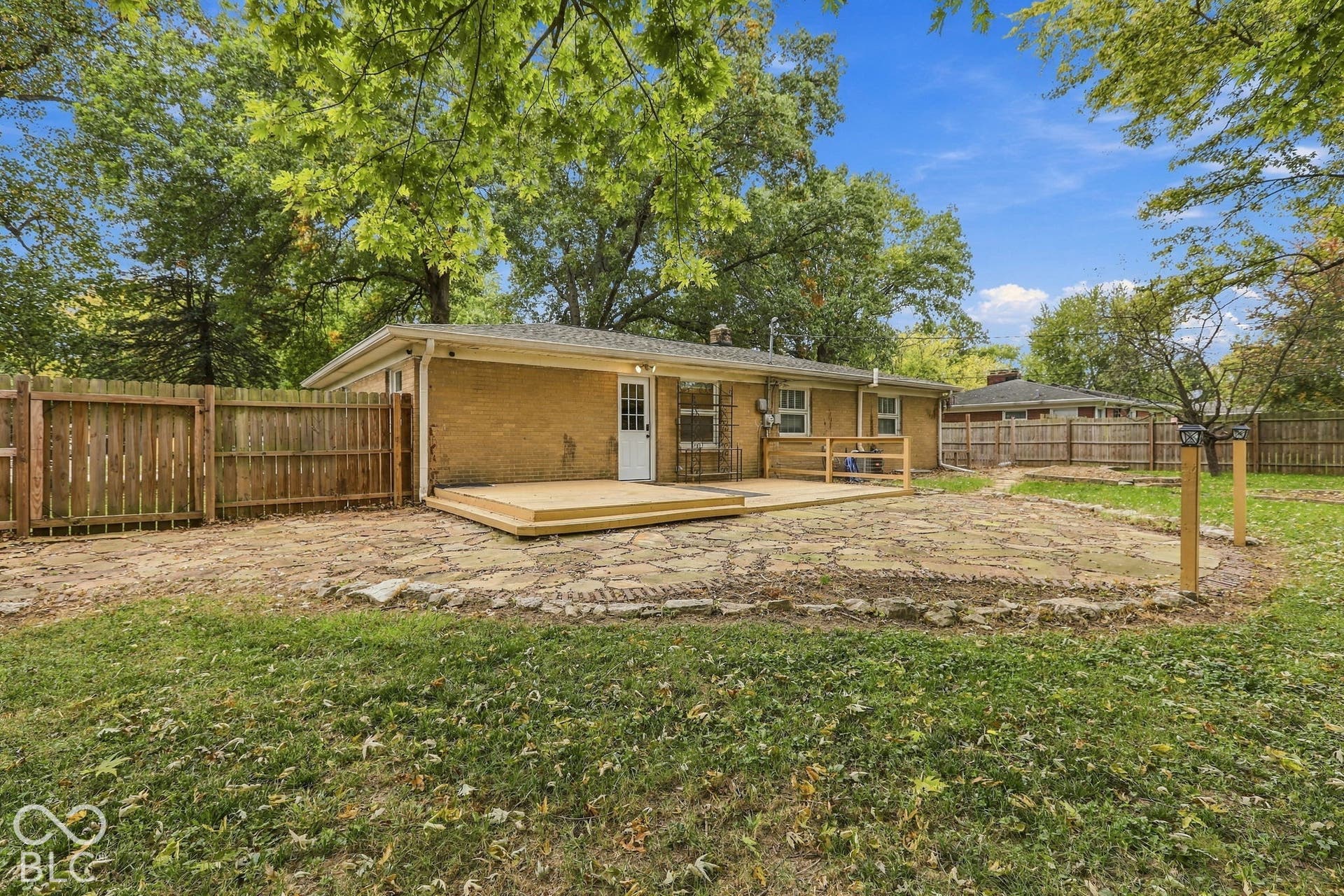 Backyard with deck, fire pit, garden areas, storage shed, full privacy fence