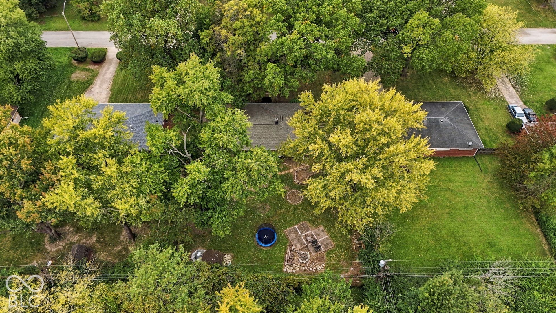 Backyard with deck, fire pit, garden areas, storage shed, full privacy fence