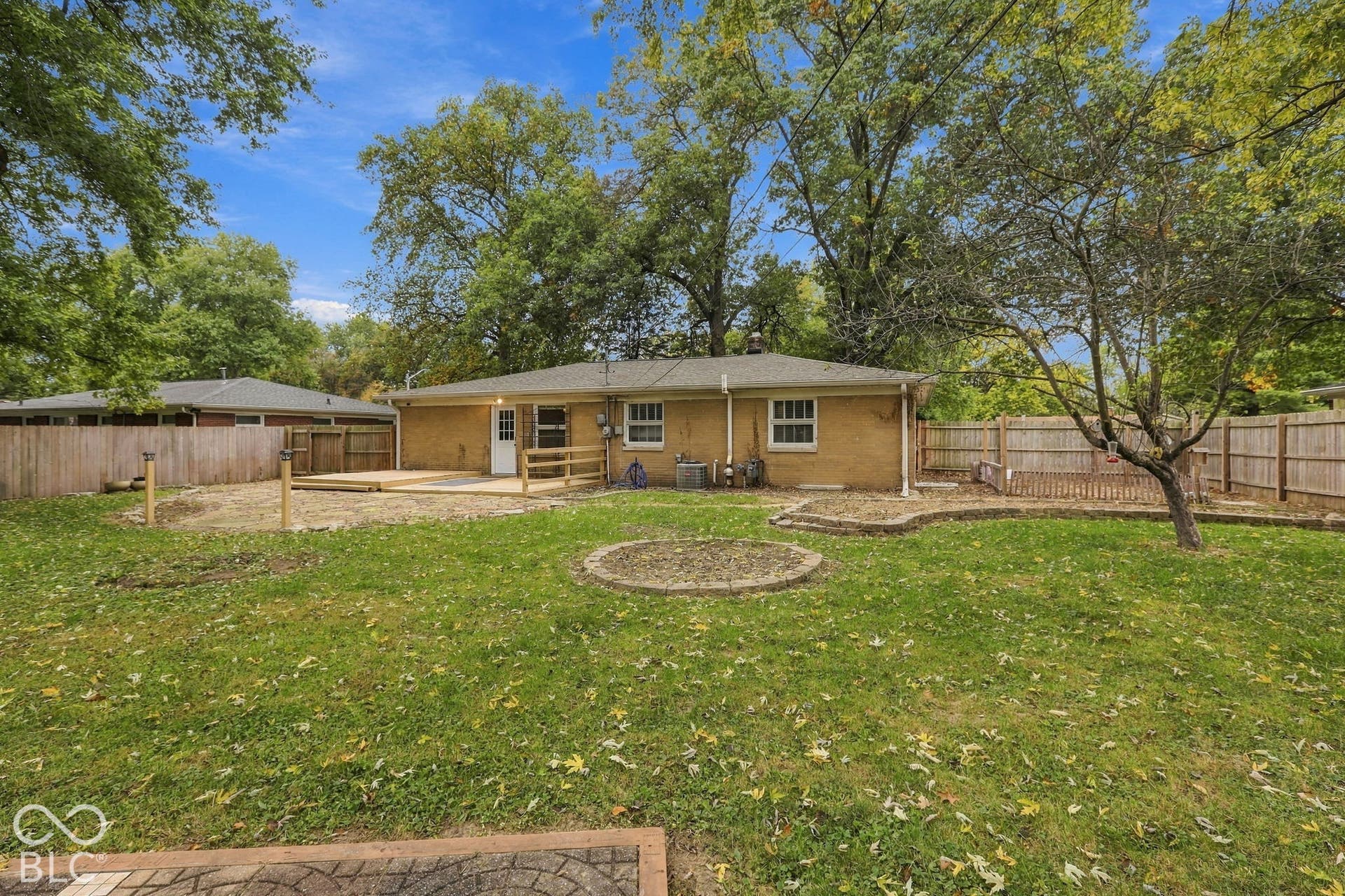 Backyard with deck, fire pit, garden areas, storage shed, full privacy fence