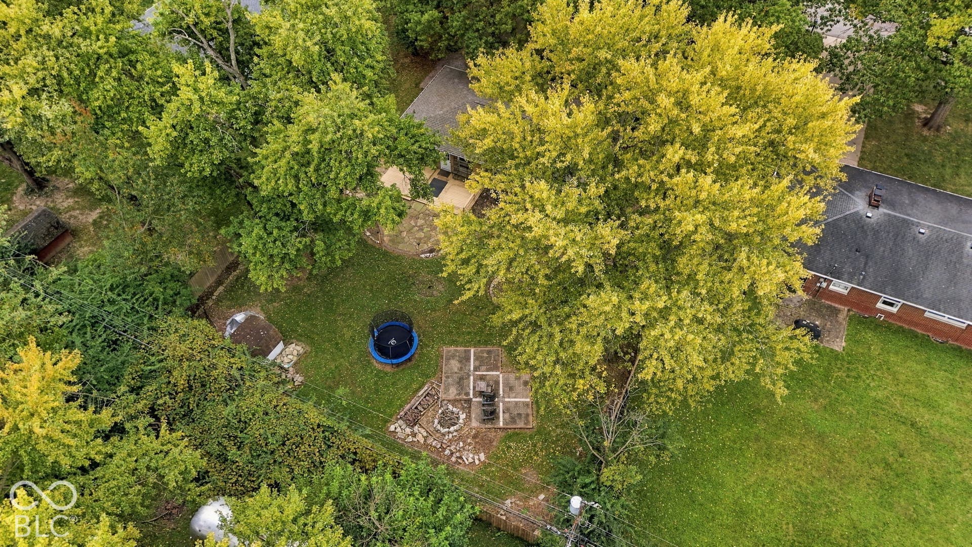 Backyard with deck, fire pit, garden areas, storage shed, full privacy fence