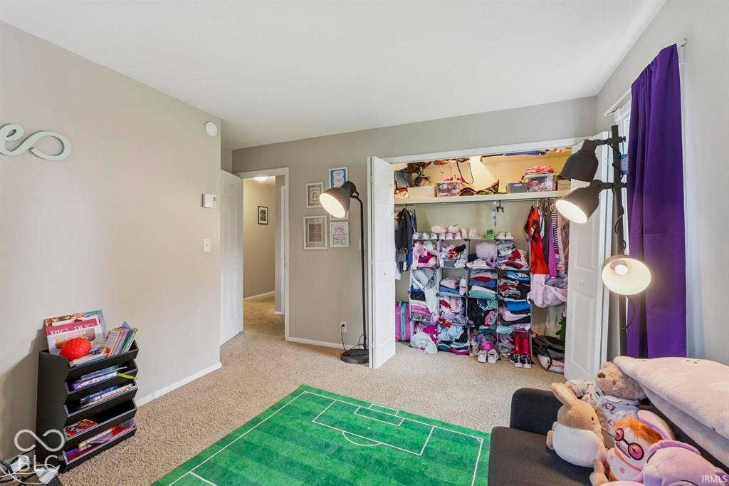 Neutral-toned walls complement the carpeted flooring
