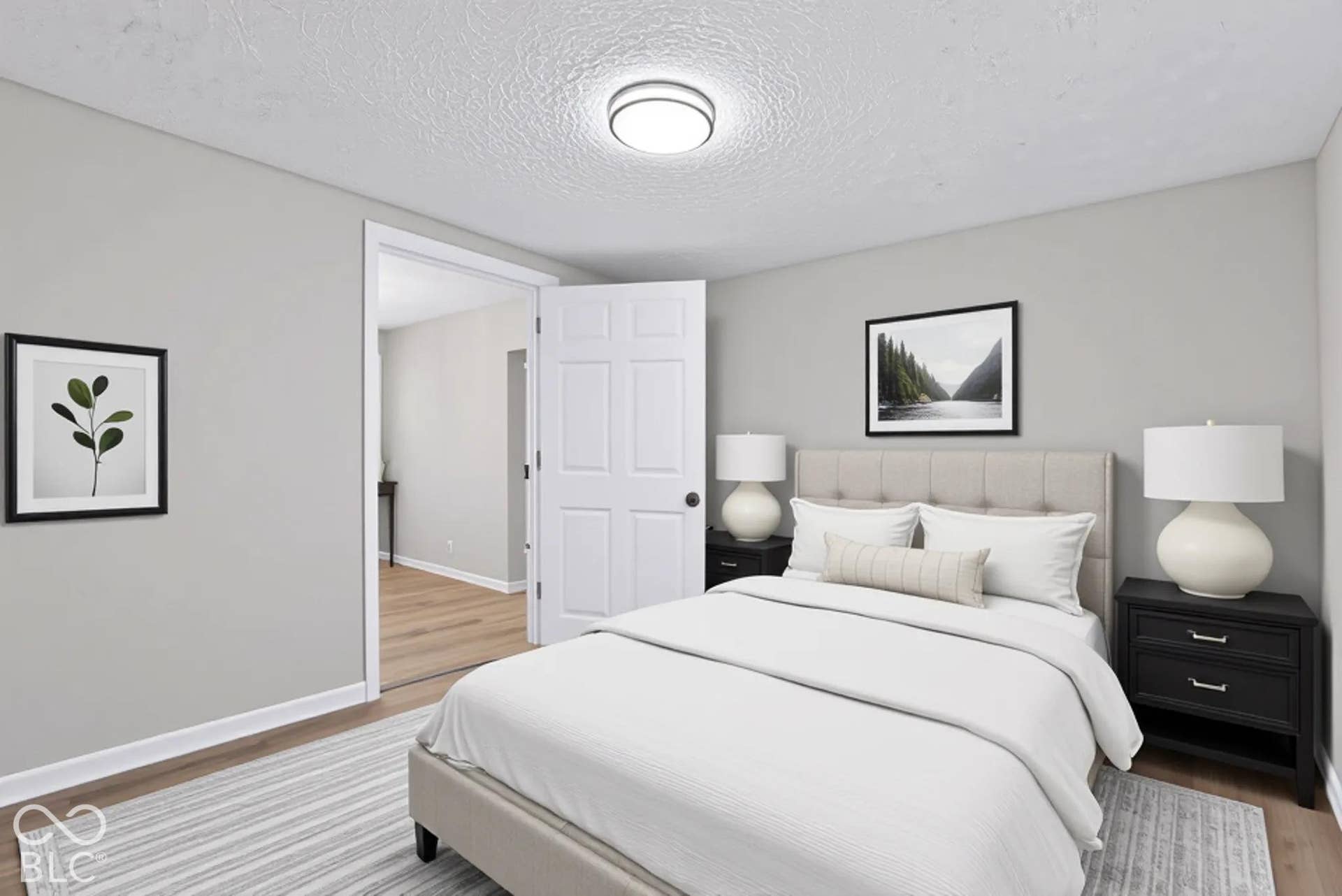 Neutral wall finishes, wood-finish flooring, recessed lighting, and a paneled interior door