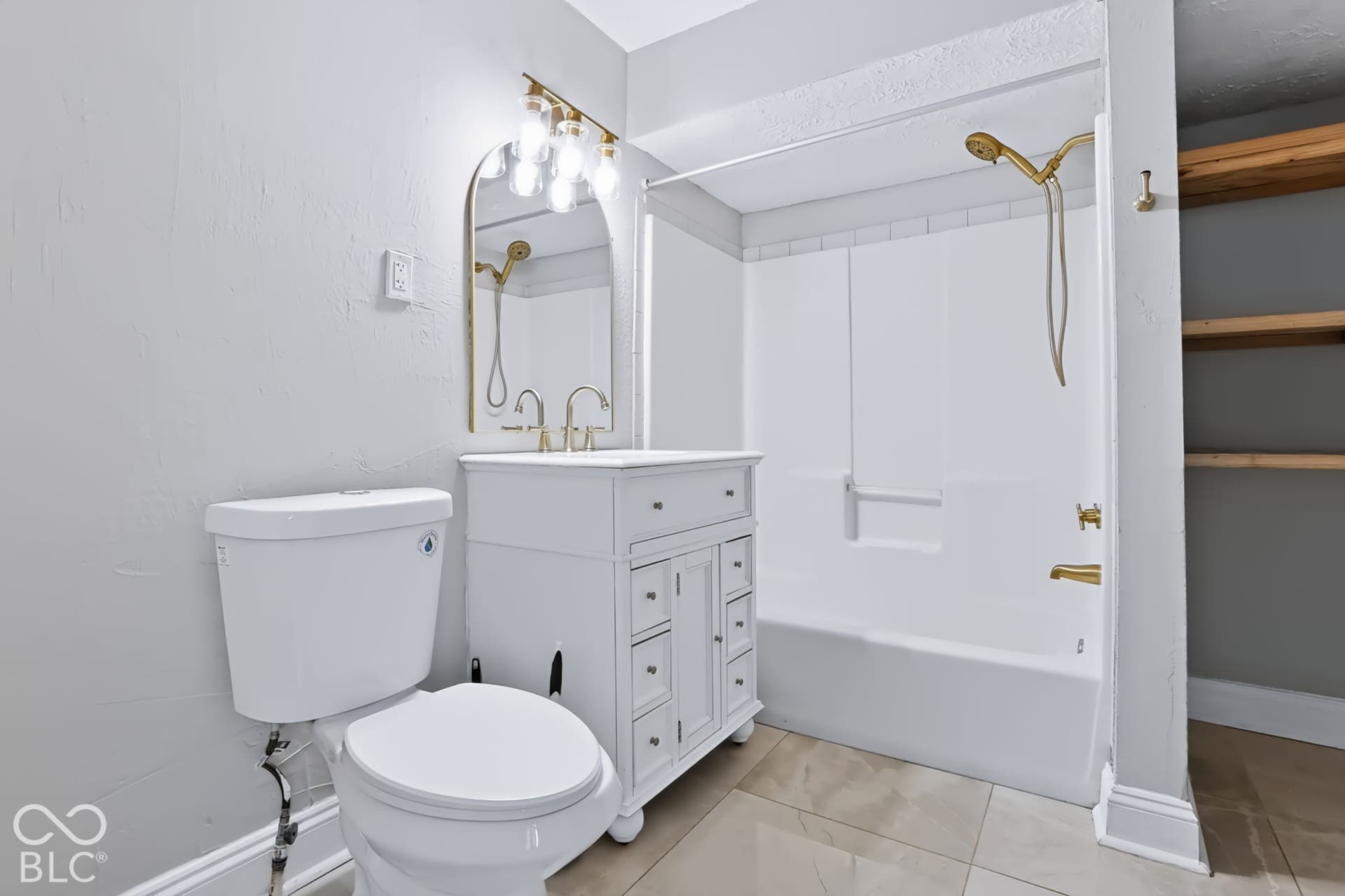 White vanity with gold-finish hardware and integrated sink