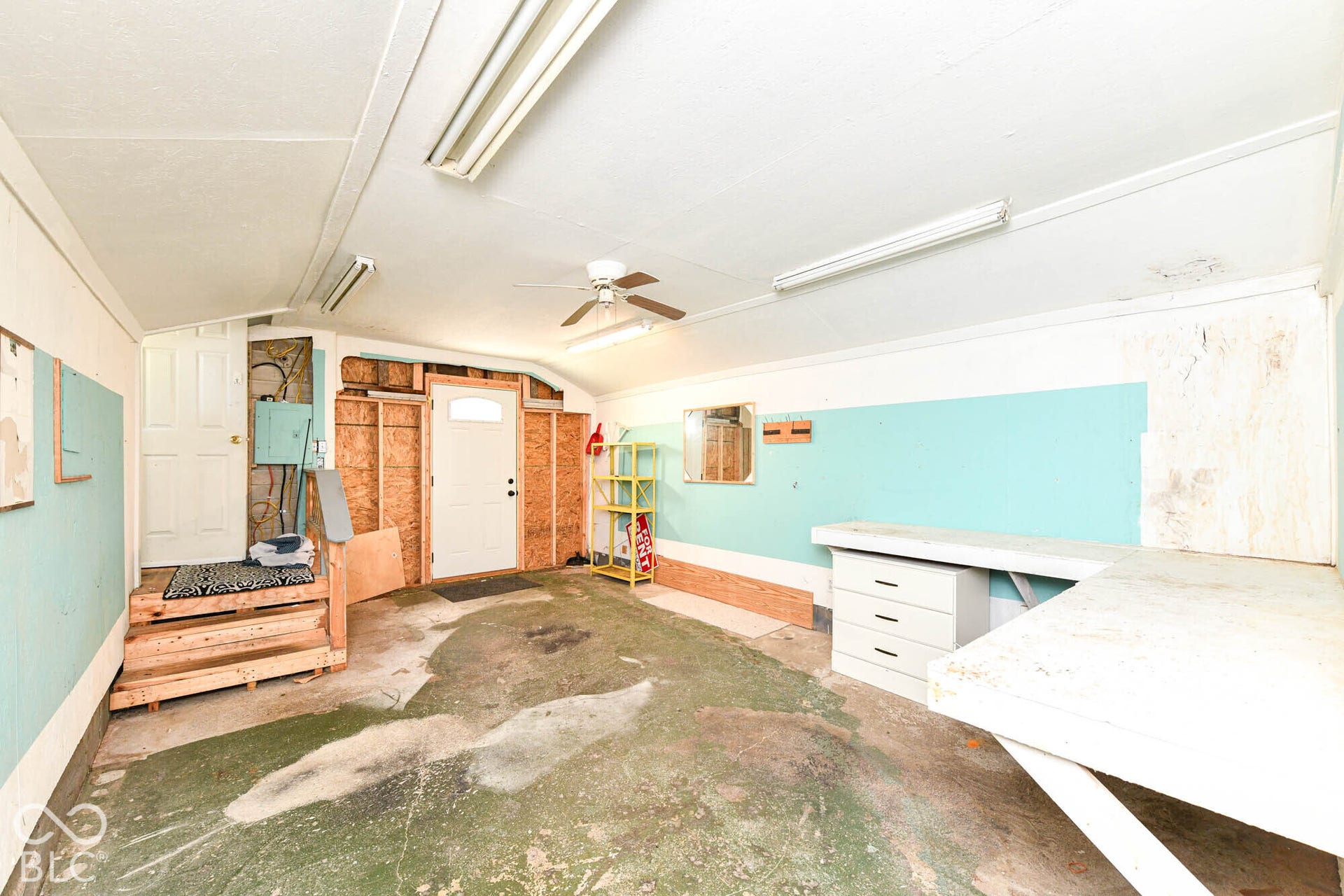896 Young Street, Franklin, IN 46131 Stairs lead inside while exterior entry door leads outside. Built-in workbench has storage drawers underneath, too.